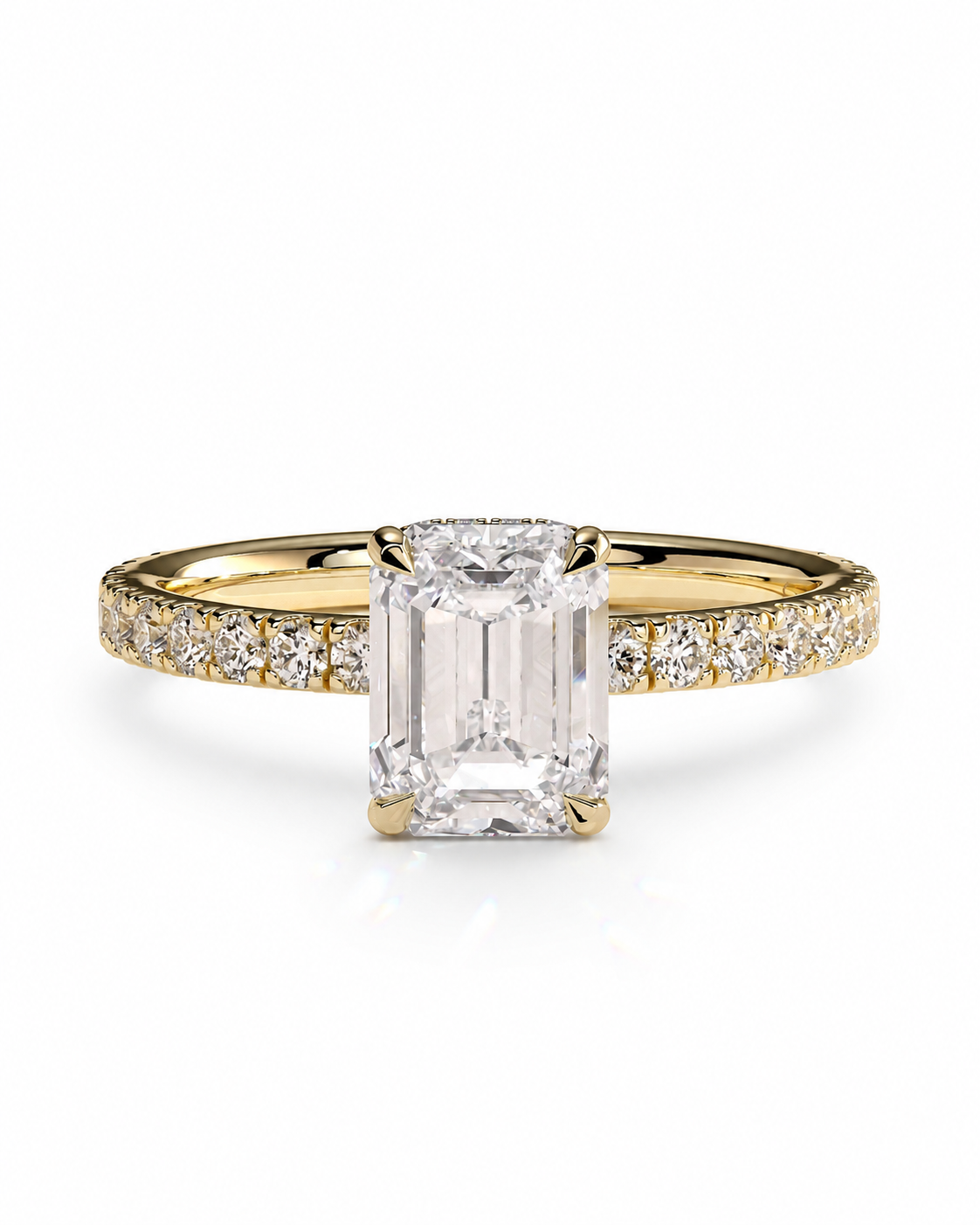 color_10K_YG, color_14K_YG &&An emerald-cut diamond engagement ring in yellow gold with pave diamonds on the band, set against a clean white background.