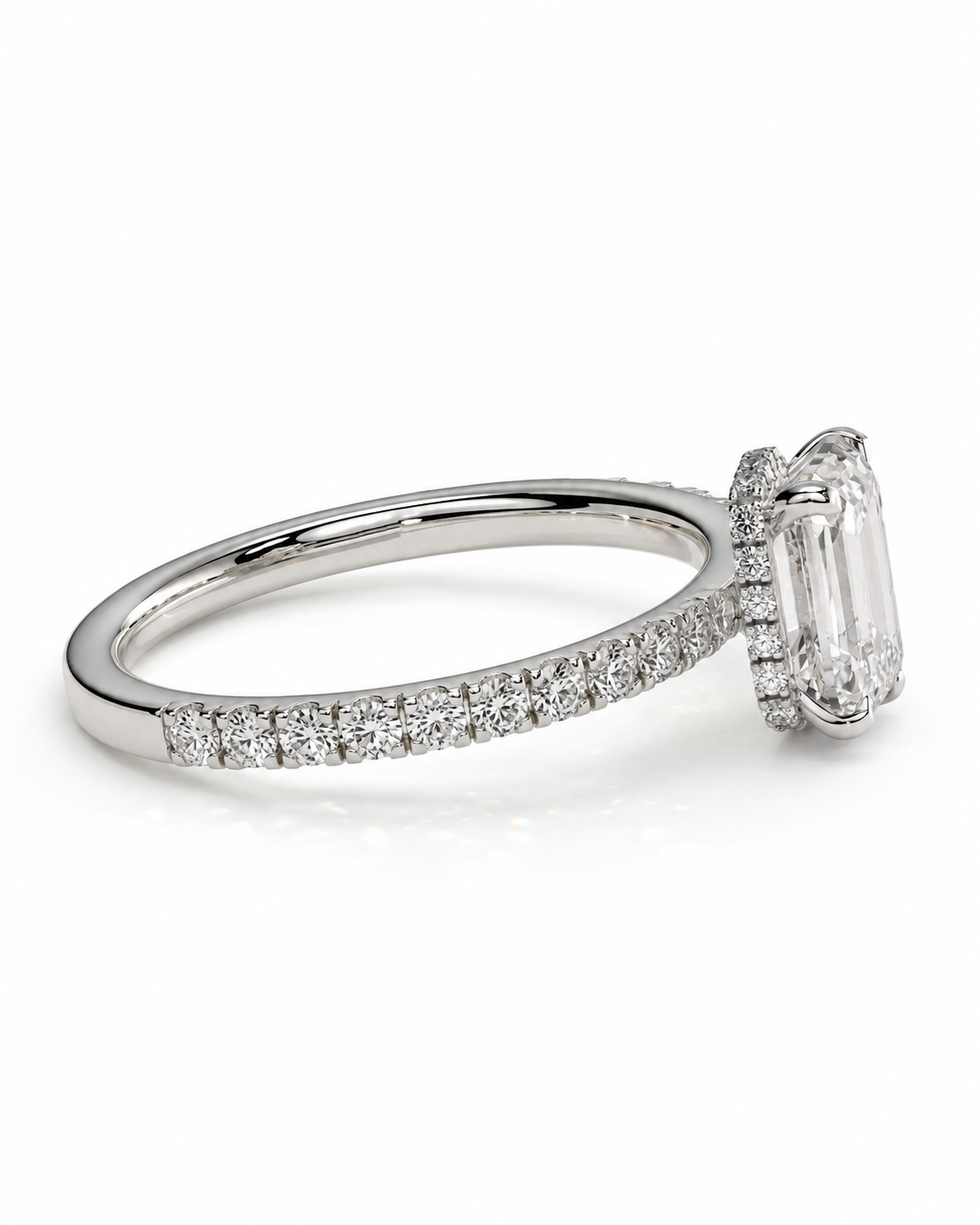 color_925_SIL,color_935_ARG,color_10K_WG, color_14K_WG &&A silver-toned diamond ring featuring an emerald-cut center stone surrounded by a halo, with a pave band, shown on a clean white background.