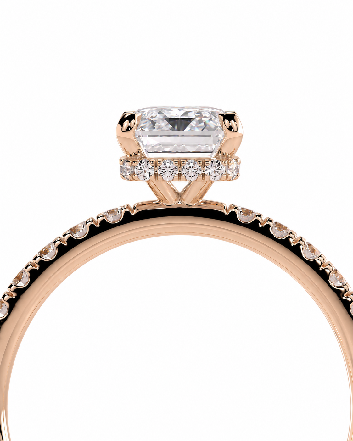 color_10K_RG, color_14K_RG &&A close-up of a rose gold engagement ring featuring a rectangular emerald-cut diamond center stone and a halo of small round diamonds, with a matching diamond pave band on a white background.