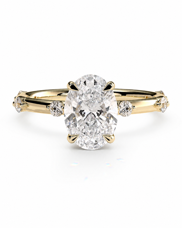 color_10K_YG, color_14K_YG &&A yellow gold ring featuring a large oval-cut center stone and smaller accent stones on the band, set against a plain white background.