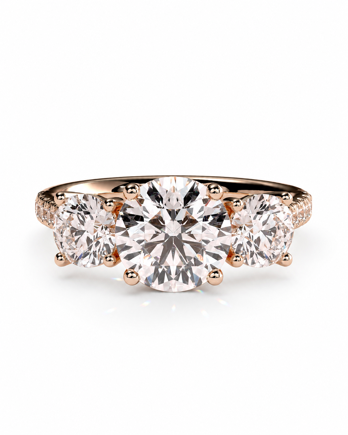 color_10K_RG, color_14K_RG &&A rose gold three-stone diamond engagement ring with a large round center stone and two round side stones, set against a clean white background.