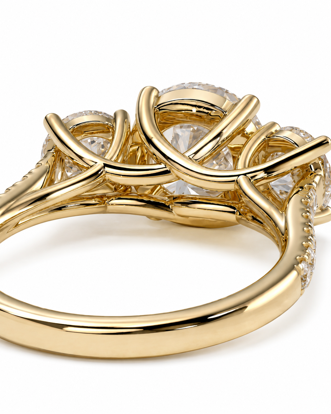 color_10K_YG, color_14K_YG &&A close-up of a gold ring featuring three round clear gemstones in a braided, interlocking setting with small accent diamonds along the band, shown on a white background.