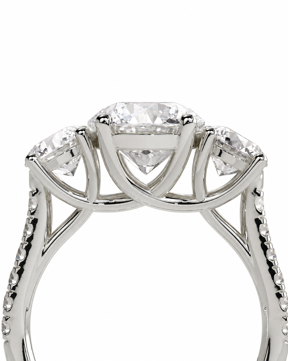 color_925_SIL,color_935_ARG,color_10K_WG, color_14K_WG &&A silver-toned three-stone diamond ring with a central round brilliant-cut diamond and two smaller round diamonds on either side, shown against a plain white background.
