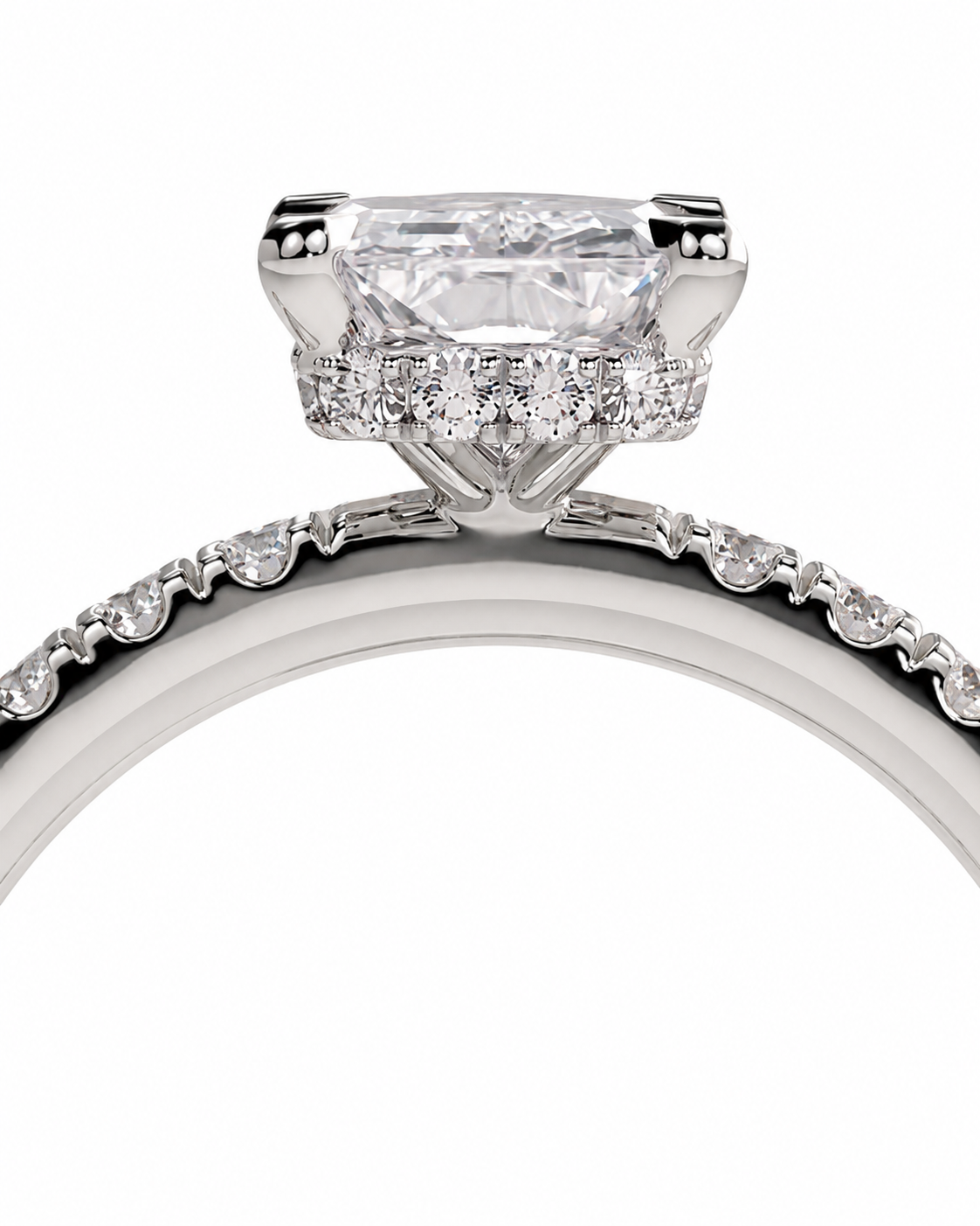 color_925_SIL,color_935_ARG,color_10K_WG, color_14K_WG &&A close-up studio shot of a silver-toned diamond ring featuring a large cushion-cut center stone and a halo of smaller diamonds, with a pave-set band visible along the lower curve against a white background.