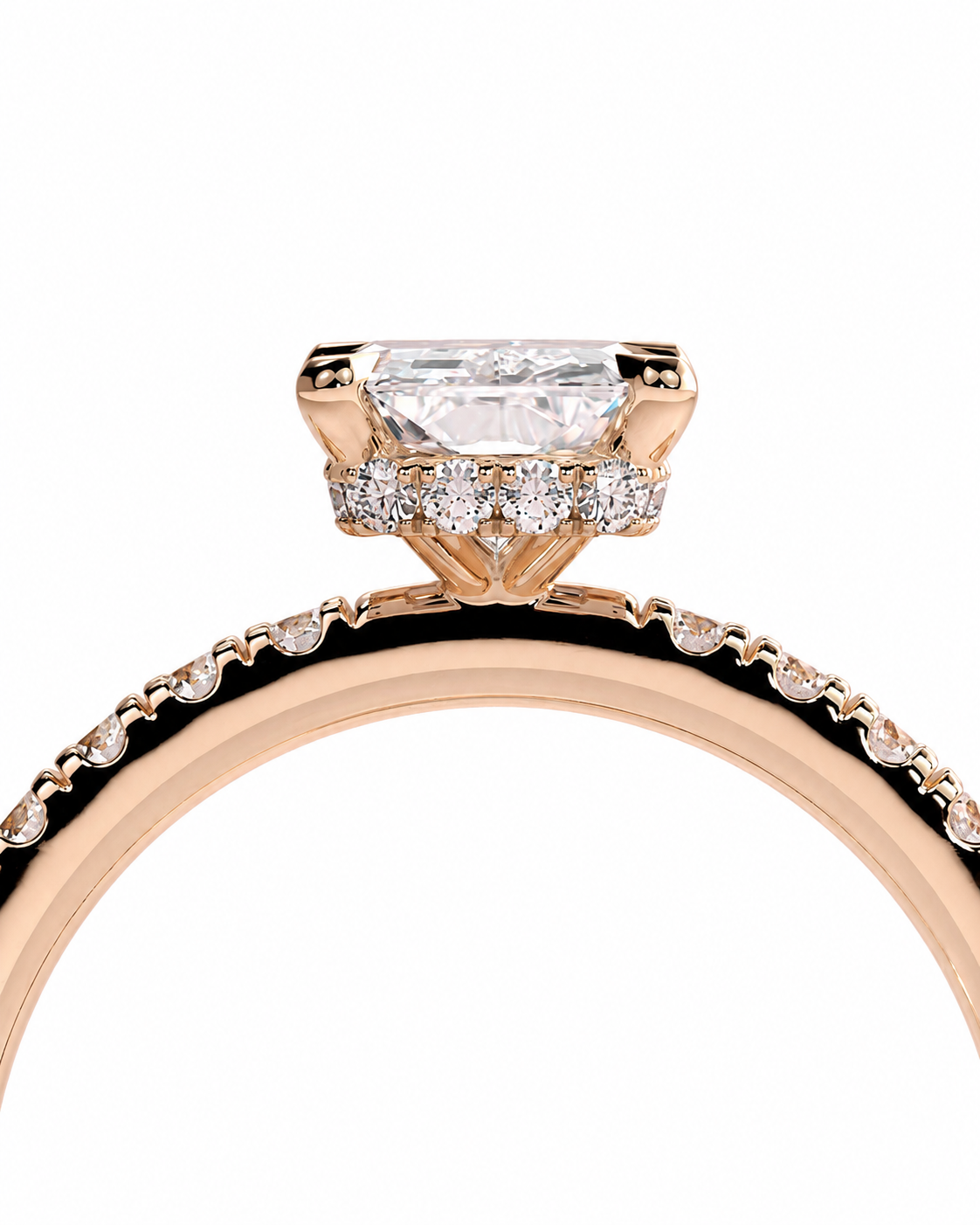 color_10K_RG, color_14K_RG &&Rose gold ring with a large rectangular clear gemstone and smaller accent stones, shown close up on a white background.