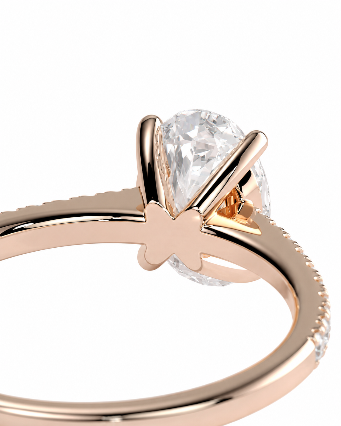 color_10K_RG, color_14K_RG &&Close-up of a rose gold ring with a pear-cut clear gemstone in a prong setting, shown against a plain white background.