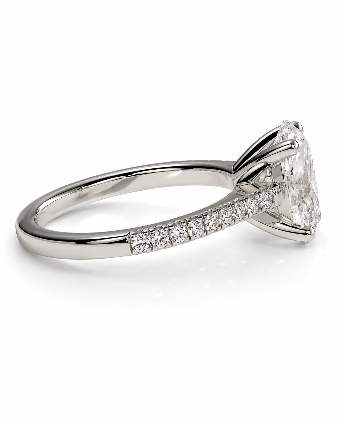 color_925_SIL,color_935_ARG,color_10K_WG, color_14K_WG &&A silver-toned diamond engagement ring featuring a large round brilliant-cut center stone in a four-prong setting, with a pave band accented by small diamonds, shown on a clean white background.