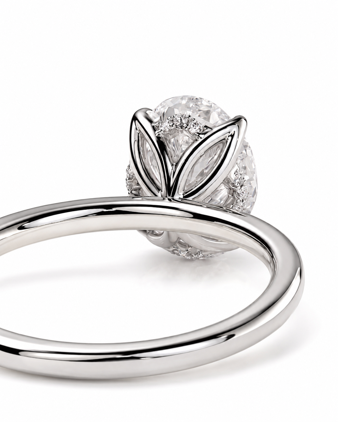 color_925_SIL,color_935_ARG,color_10K_WG, color_14K_WG &&A close-up studio shot of a silver-toned ring with a large oval clear gemstone and marquise-cut side stones, photographed on a clean white background.