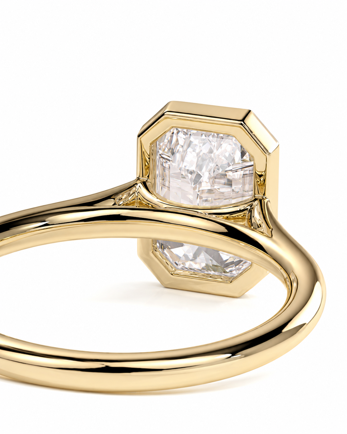 color_10K_YG, color_14K_YG &&A close-up studio shot of a gold ring featuring a large clear rectangular gemstone in a bezel setting, with a second smaller clear gemstone visible beneath it on a white background.