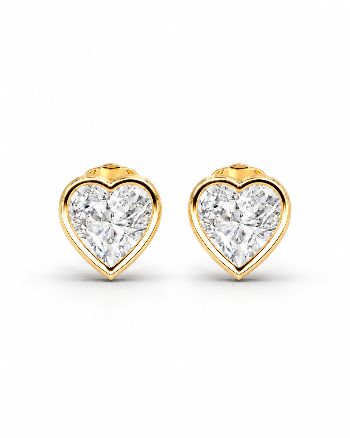 color_10K_YG, color_14K_YG &&A pair of heart-shaped stud earrings featuring brilliant-cut clear gemstones in a polished yellow gold bezel setting, presented on a clean white background.