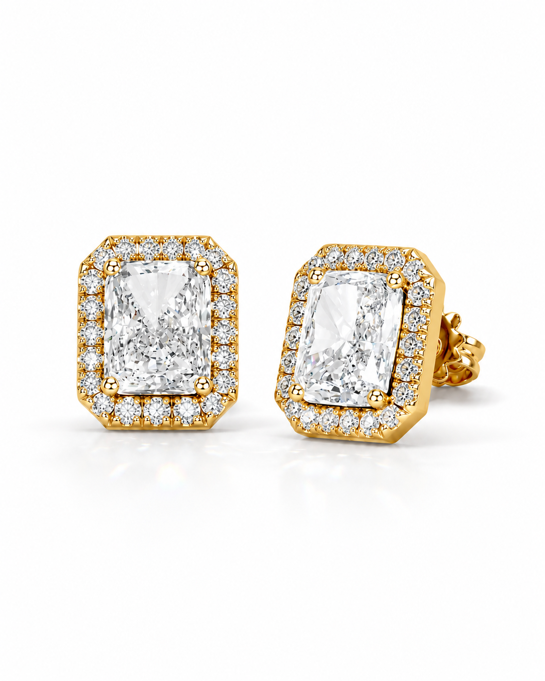 color_10K_YG, color_14K_YG &&A pair of yellow gold stud earrings featuring large rectangular emerald-cut diamonds surrounded by a halo of smaller round diamonds, set against a clean white background.