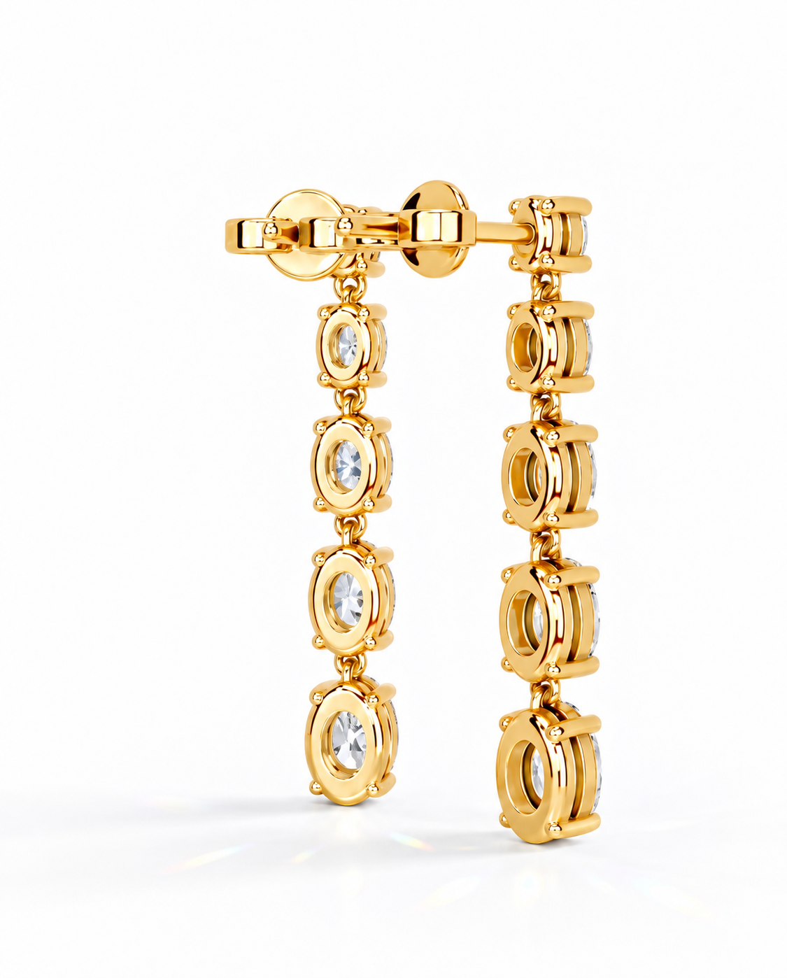 color_10K_YG, color_14K_YG &&A pair of gold dangle earrings with oval-cut clear gemstones, displayed on a clean white background.