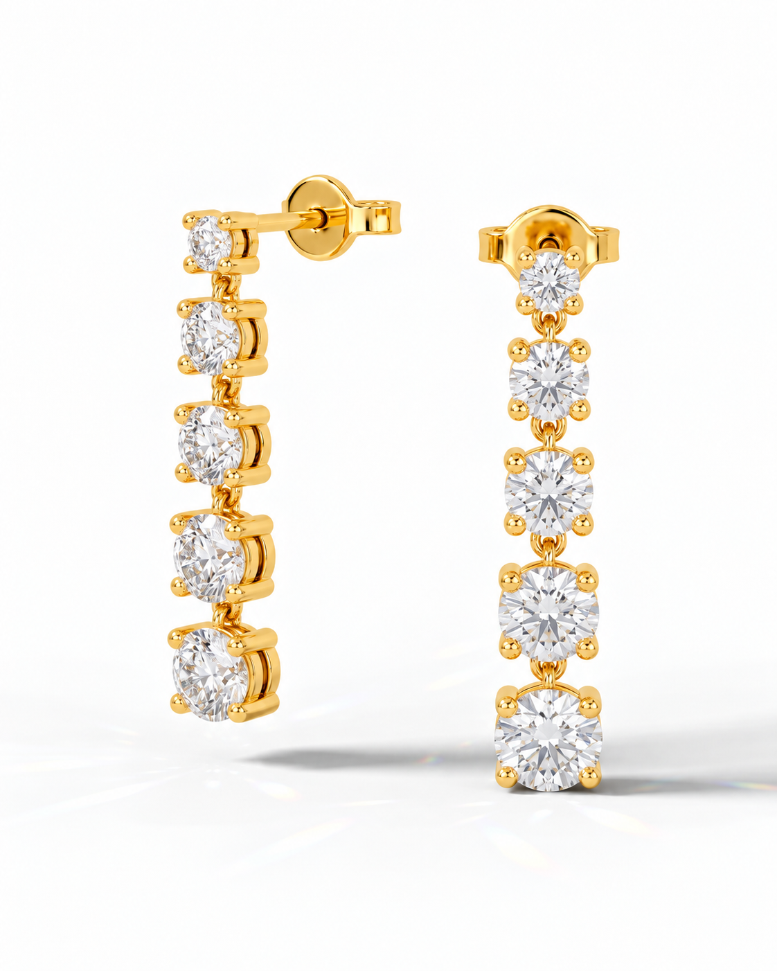 color_10K_YG, color_14K_YG &&A pair of gold drop earrings with five clear round-cut gemstones in a vertical setting, shown on a clean white background.