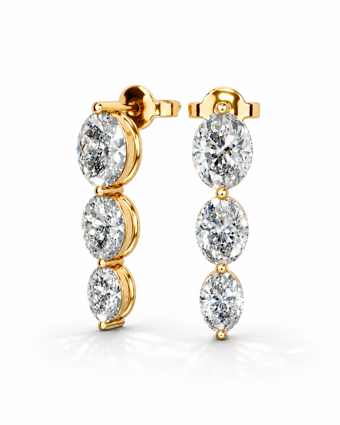color_10K_YG, color_14K_YG &&A pair of gold drop earrings with three oval-cut clear gemstones each, shown on a clean white background.