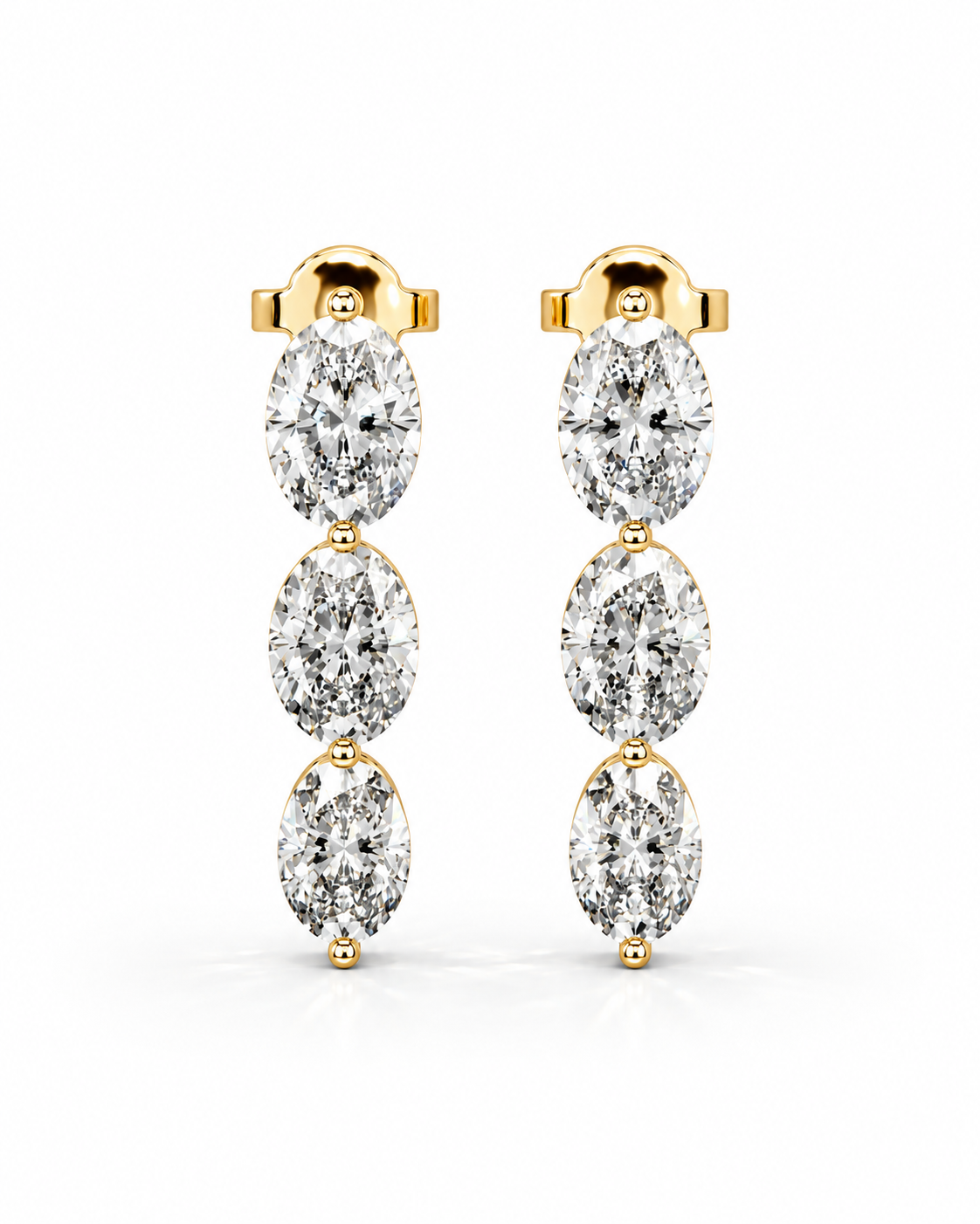 color_10K_YG, color_14K_YG &&A pair of gold drop earrings featuring three marquise-cut diamonds in a vertical arrangement, set in yellow gold posts against a clean white background.