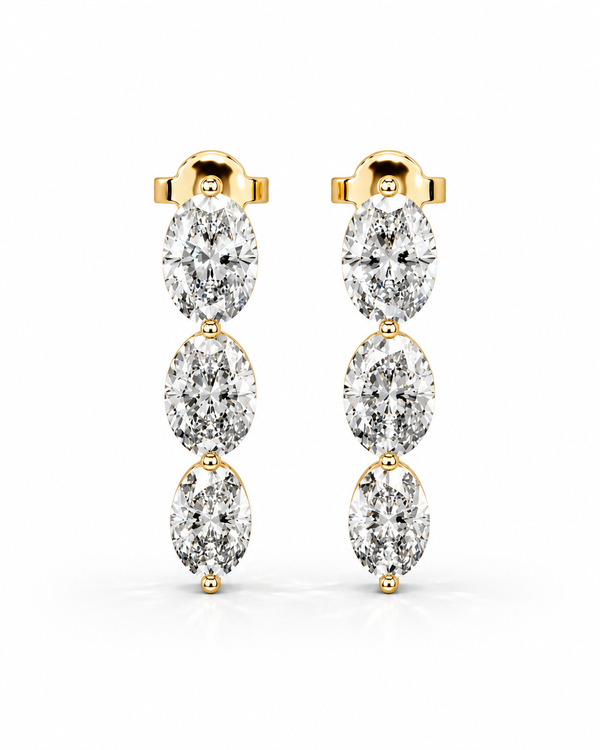 color_10K_YG, color_14K_YG &&A pair of gold drop earrings featuring three marquise-cut diamonds in a vertical arrangement, set in yellow gold posts against a clean white background.