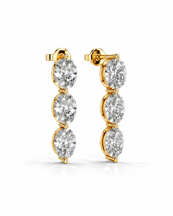 color_10K_YG, color_14K_YG &&A pair of gold drop earrings with three oval-cut clear gemstones each, shown on a clean white background.