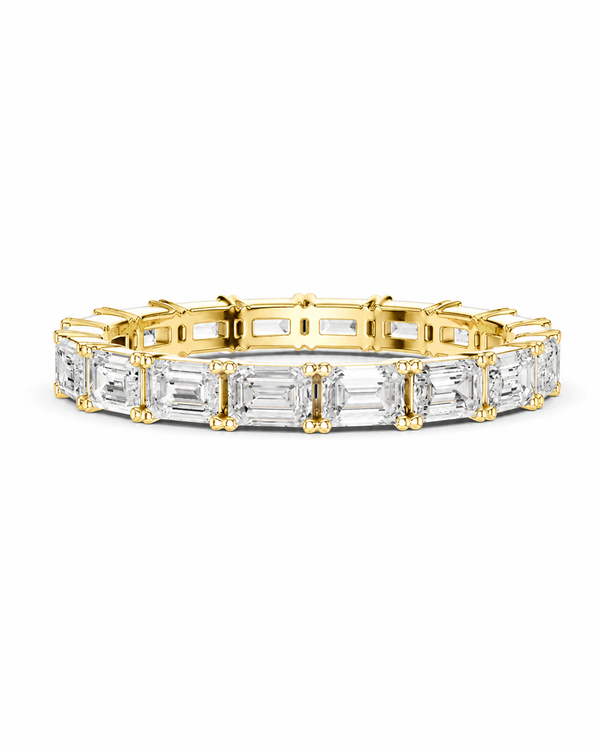 color_10K_YG, color_14K_YG &&A yellow gold tennis bracelet featuring baguette-cut clear gemstones, displayed against a clean white background.