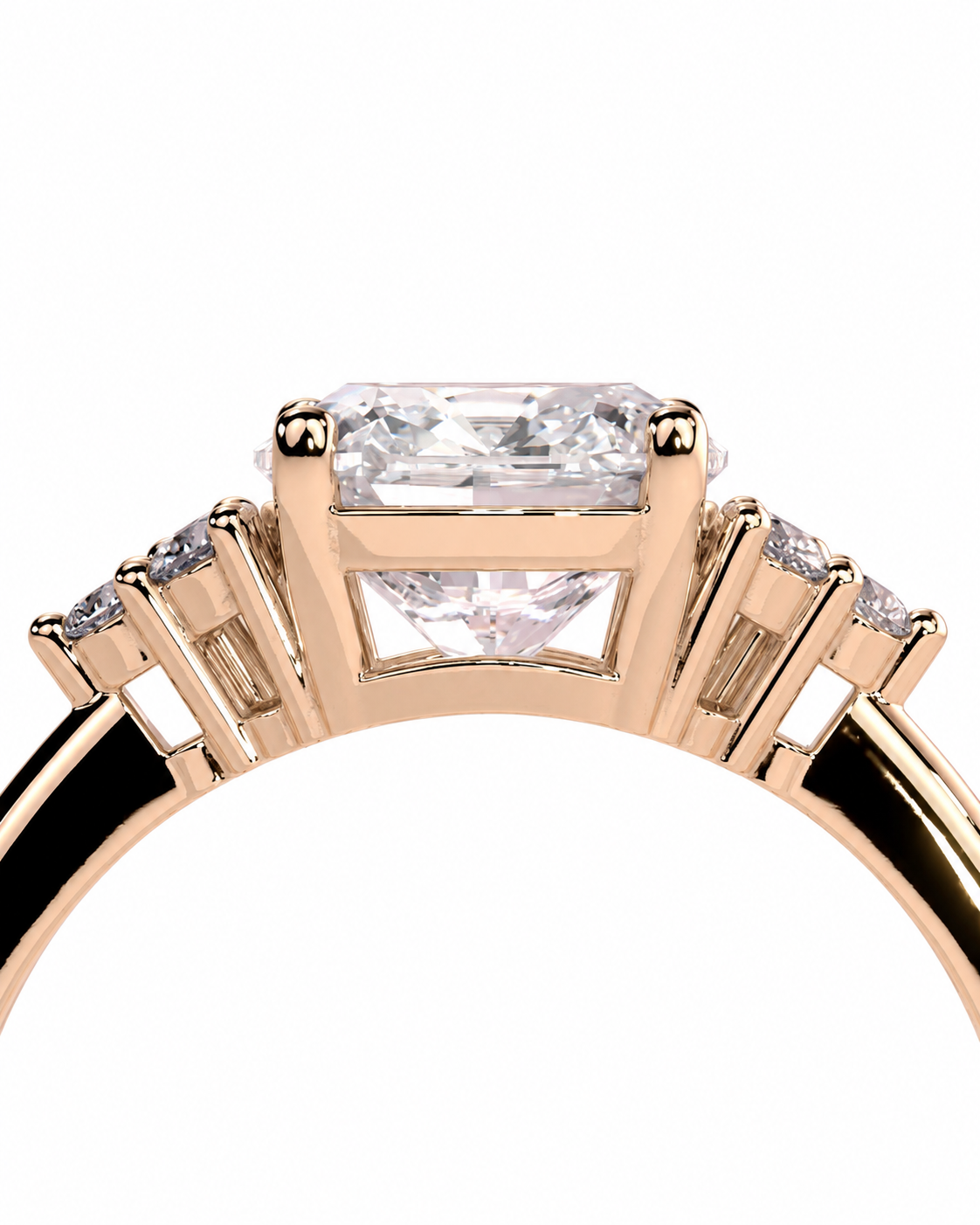color_10K_RG, color_14K_RG &&Rose gold ring with a large rectangular clear gemstone in a prong setting, flanked by smaller side stones on a white background.