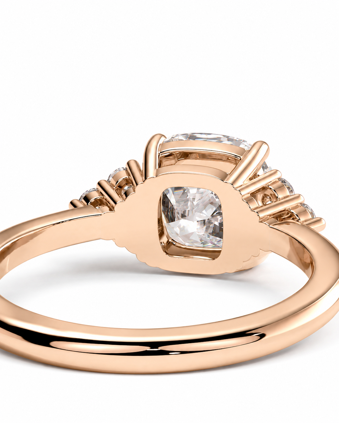 color_10K_RG, color_14K_RG &&Rose gold ring with a cushion-cut center diamond and smaller side diamonds, shown on a clean white background.