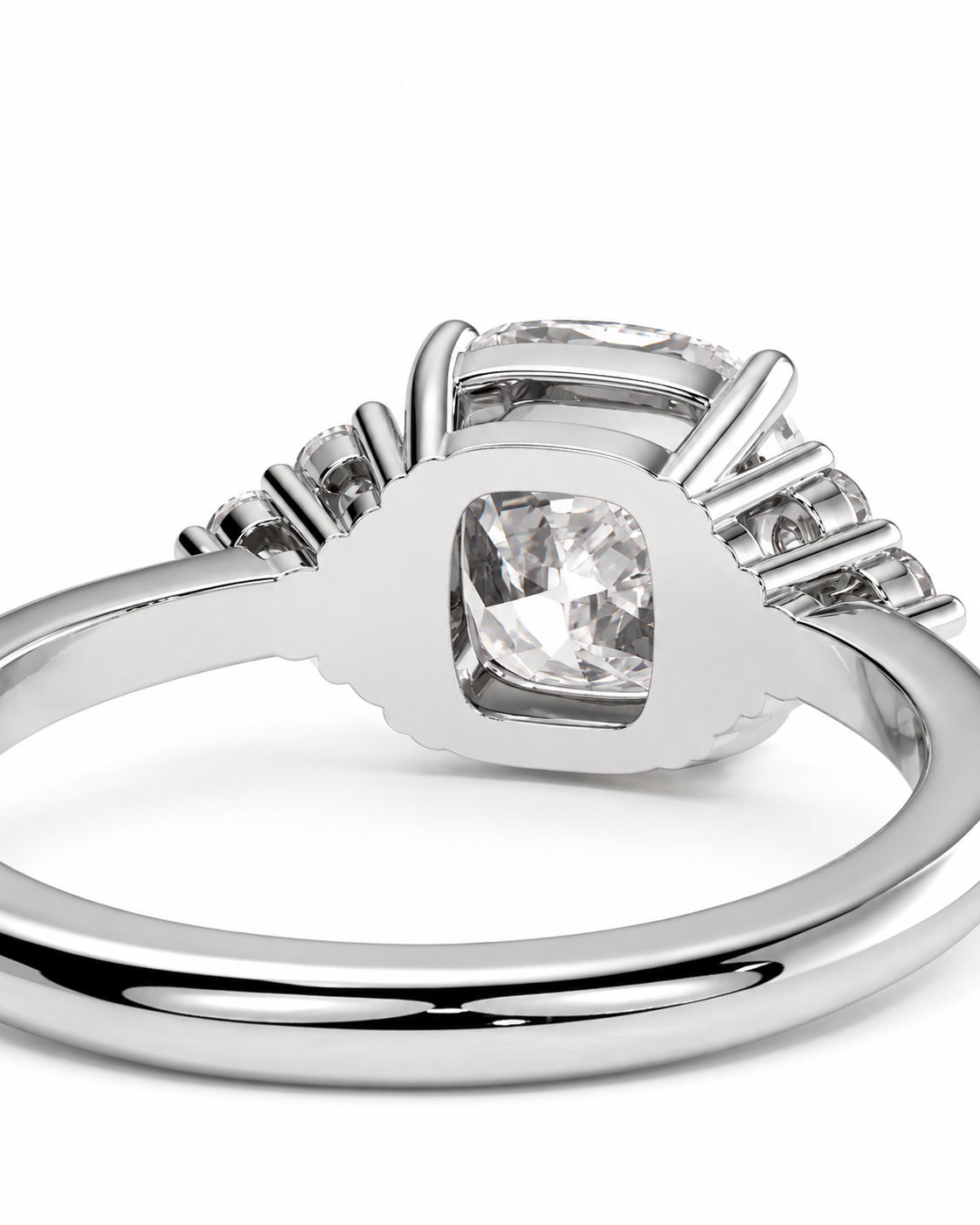 color_925_SIL,color_935_ARG,color_10K_WG, color_14K_WG &&A close-up studio shot of a silver-toned ring featuring a cushion-cut clear center stone and smaller accent stones along the shoulders, set against a plain white background.