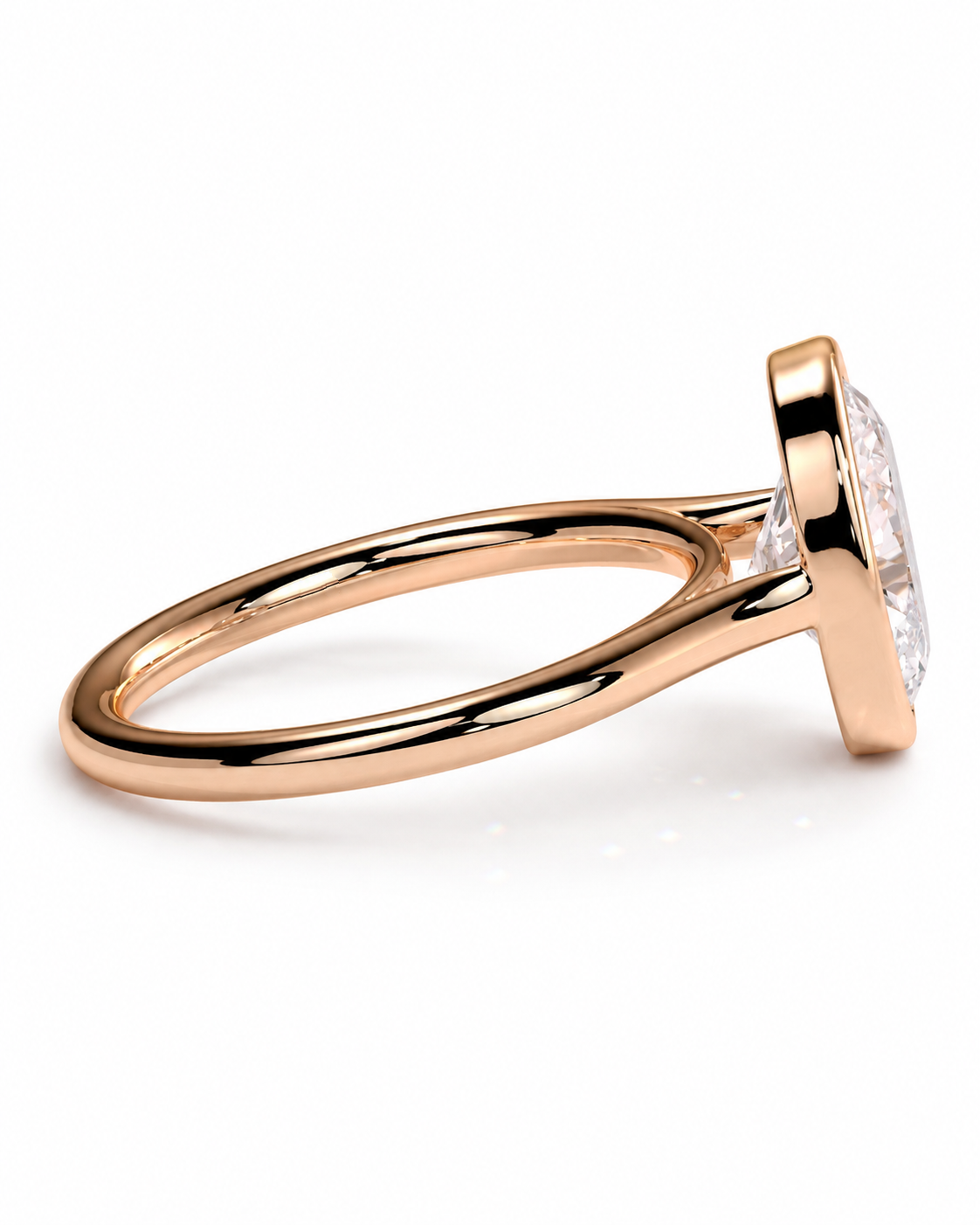 color_10K_RG, color_14K_RG &&A rose gold ring with a bezel-set clear gemstone, shown in a side profile view on a clean white background.