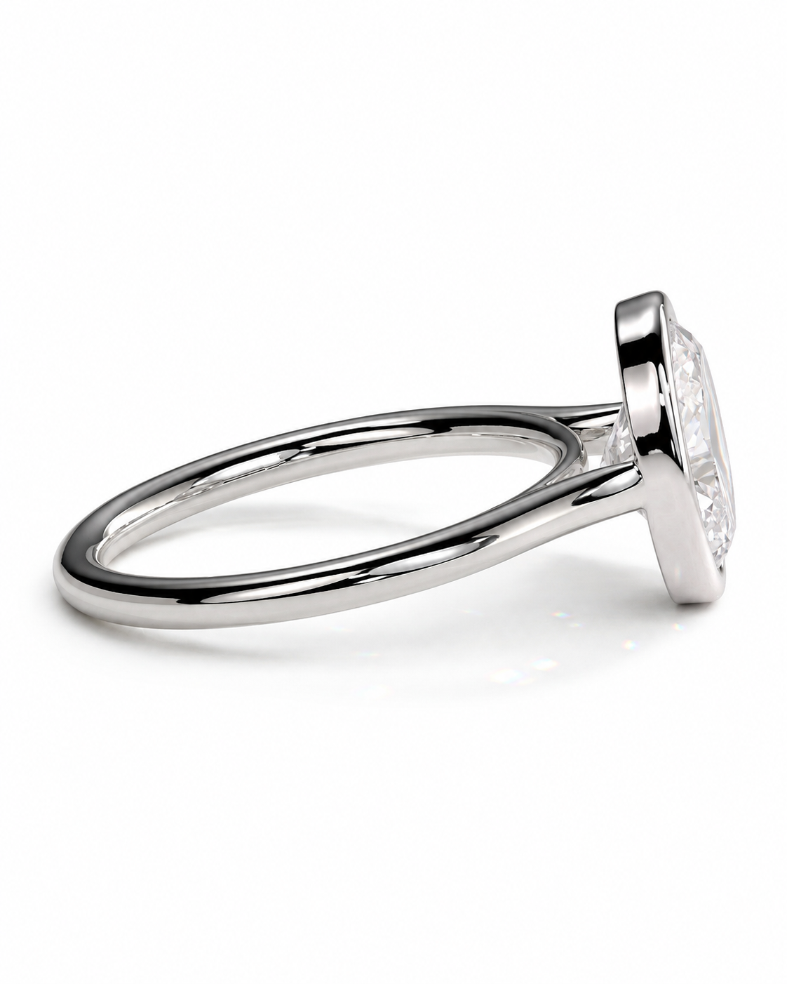 color_925_SIL,color_935_ARG,color_10K_WG, color_14K_WG &&A silver-toned ring with a bezel-set clear gemstone, shown in a side profile view on a clean white background.