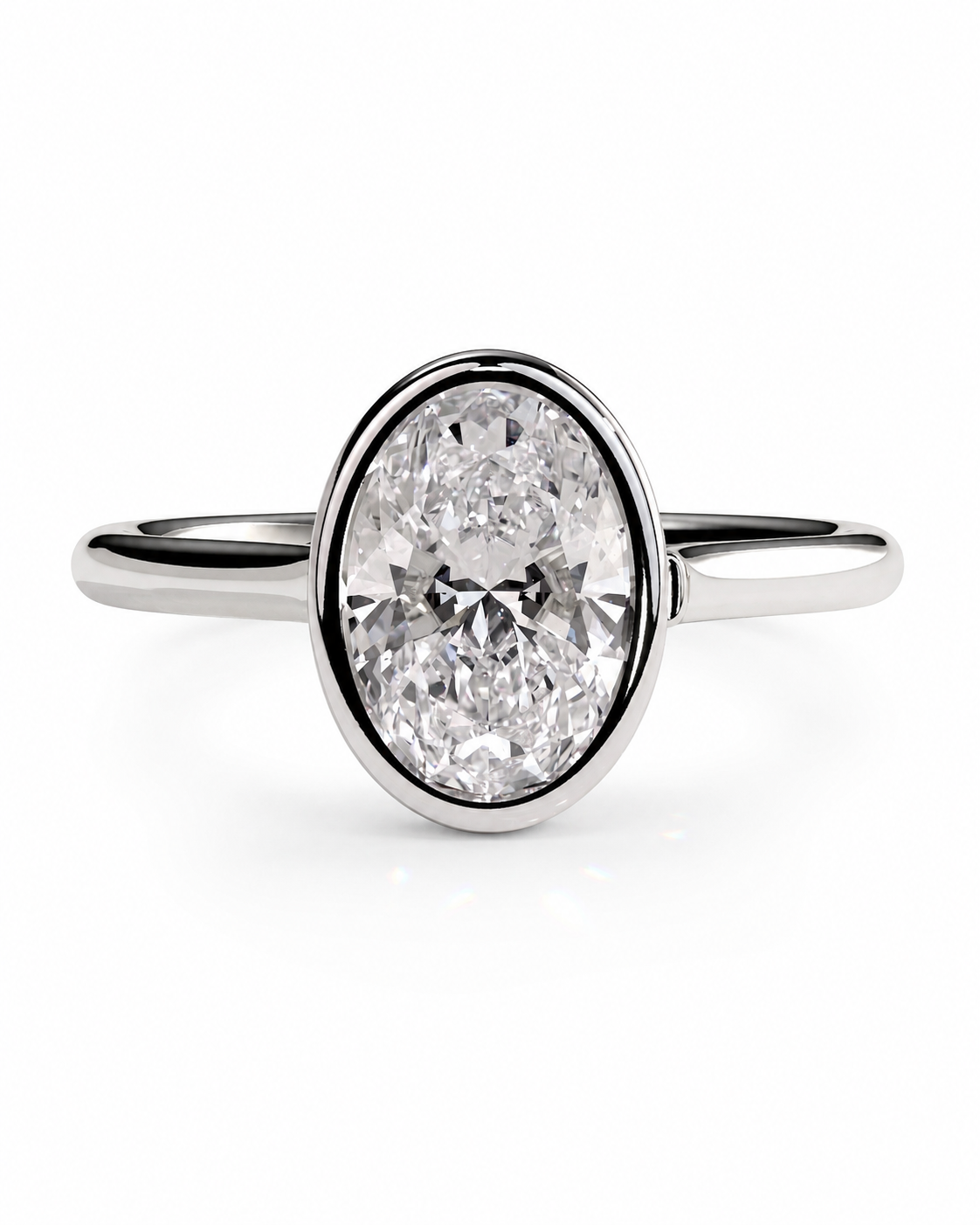 color_925_SIL,color_935_ARG,color_10K_WG, color_14K_WG &&An oval-cut diamond engagement ring with a polished silver-colored band, set against a clean white background.