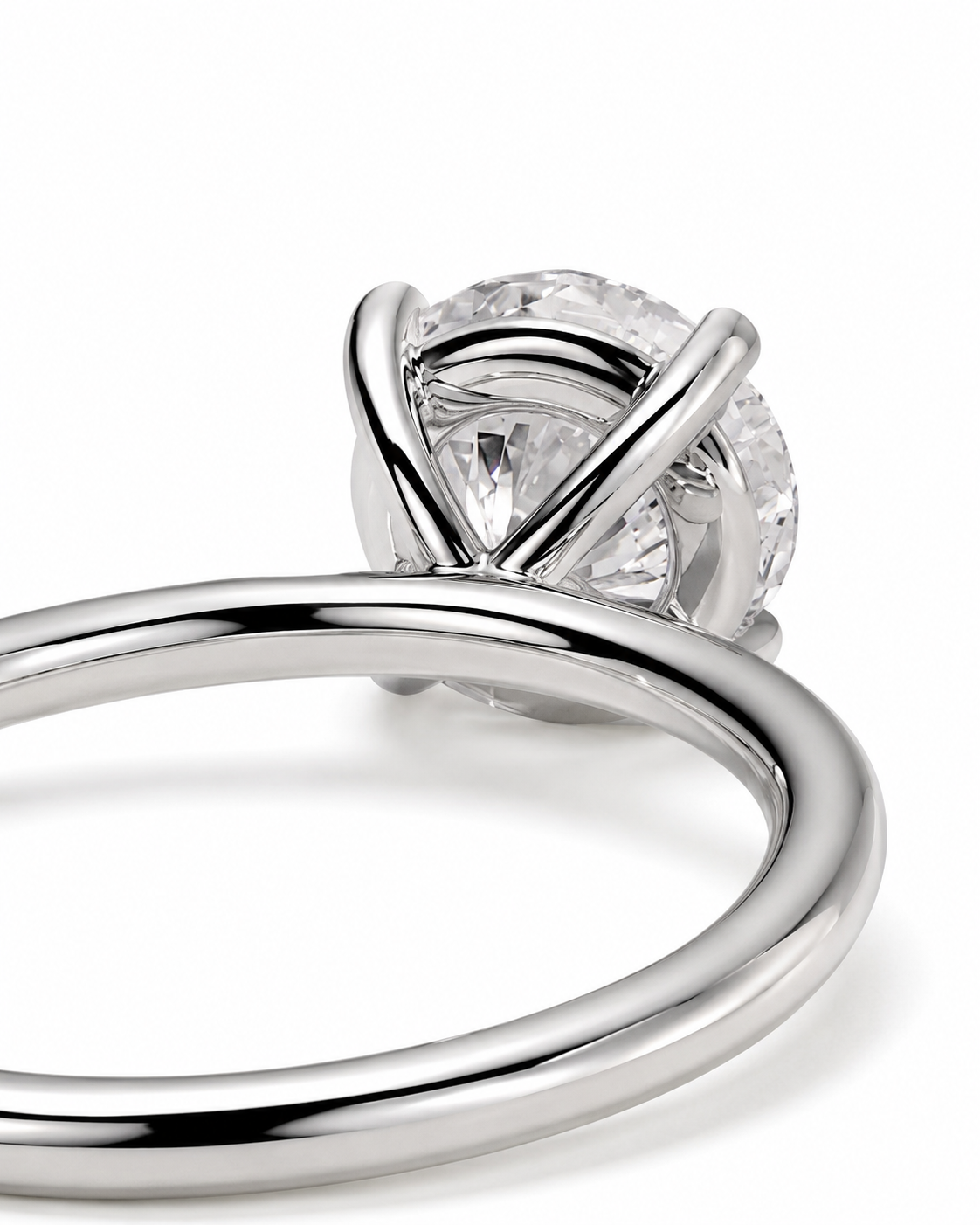 color_925_SIL,color_935_ARG,color_10K_WG, color_14K_WG &&A close-up studio shot of a silver-toned solitaire engagement ring with a round brilliant-cut diamond, set against a clean white background.