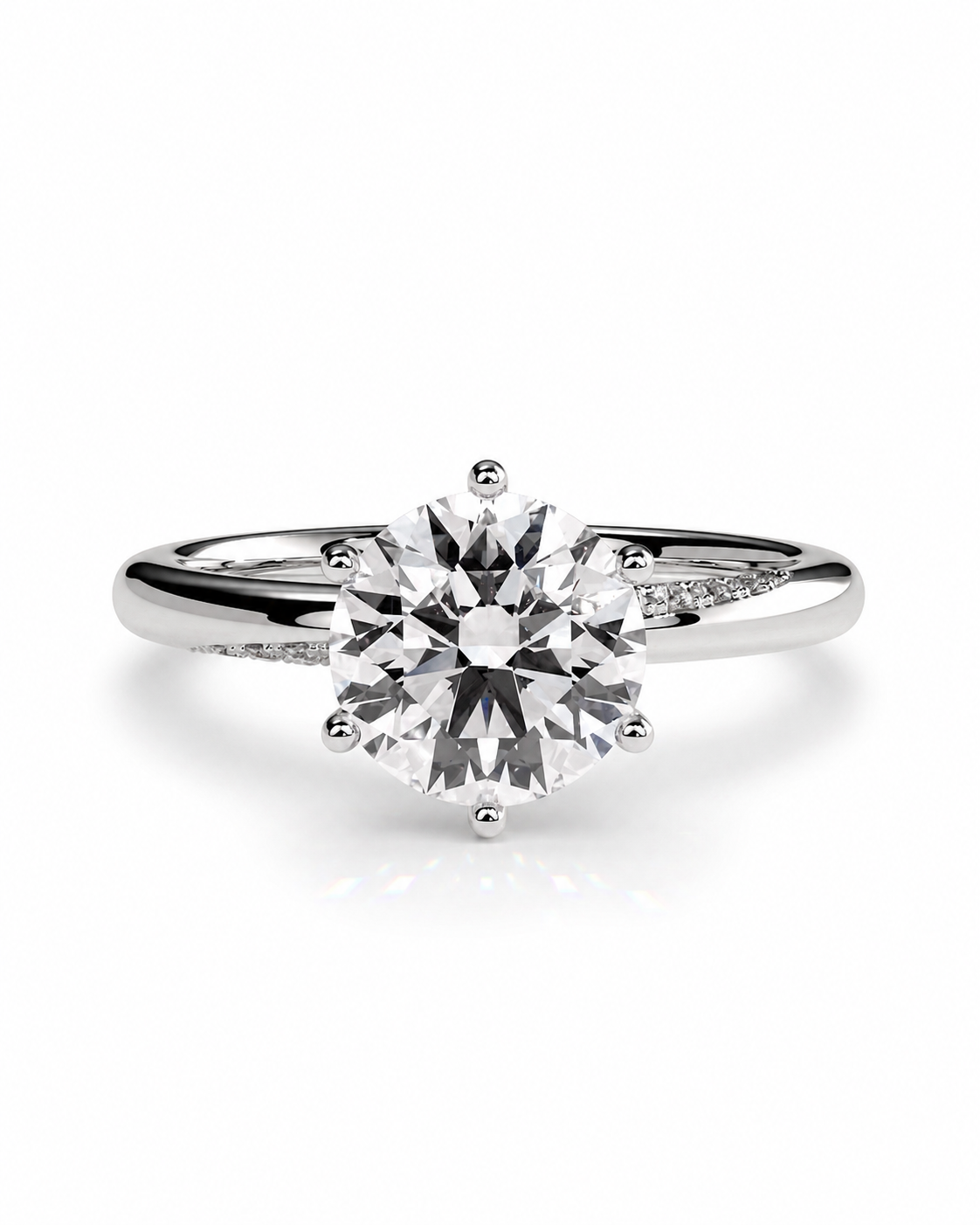 color_925_SIL,color_935_ARG,color_10K_WG, color_14K_WG &&A classic solitaire engagement ring featuring a round brilliant-cut diamond set in a polished white gold or platinum band with a subtle pavé accent on the shoulders, shown on a clean white background.