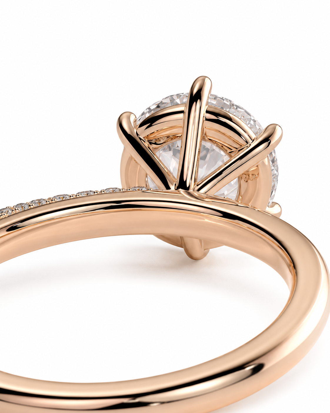 color_10K_RG, color_14K_RG &&Close-up of a rose gold ring with a large round clear gemstone in a prong setting, with a pavé band on a white background.