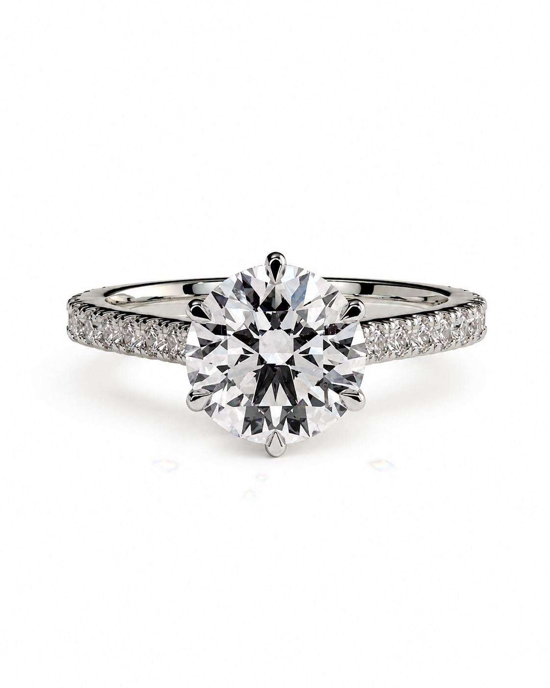 color_925_SIL,color_935_ARG,color_10K_WG, color_14K_WG &&A round-cut diamond solitaire engagement ring with a pavé band, set in a silver-colored metal on a clean white background.