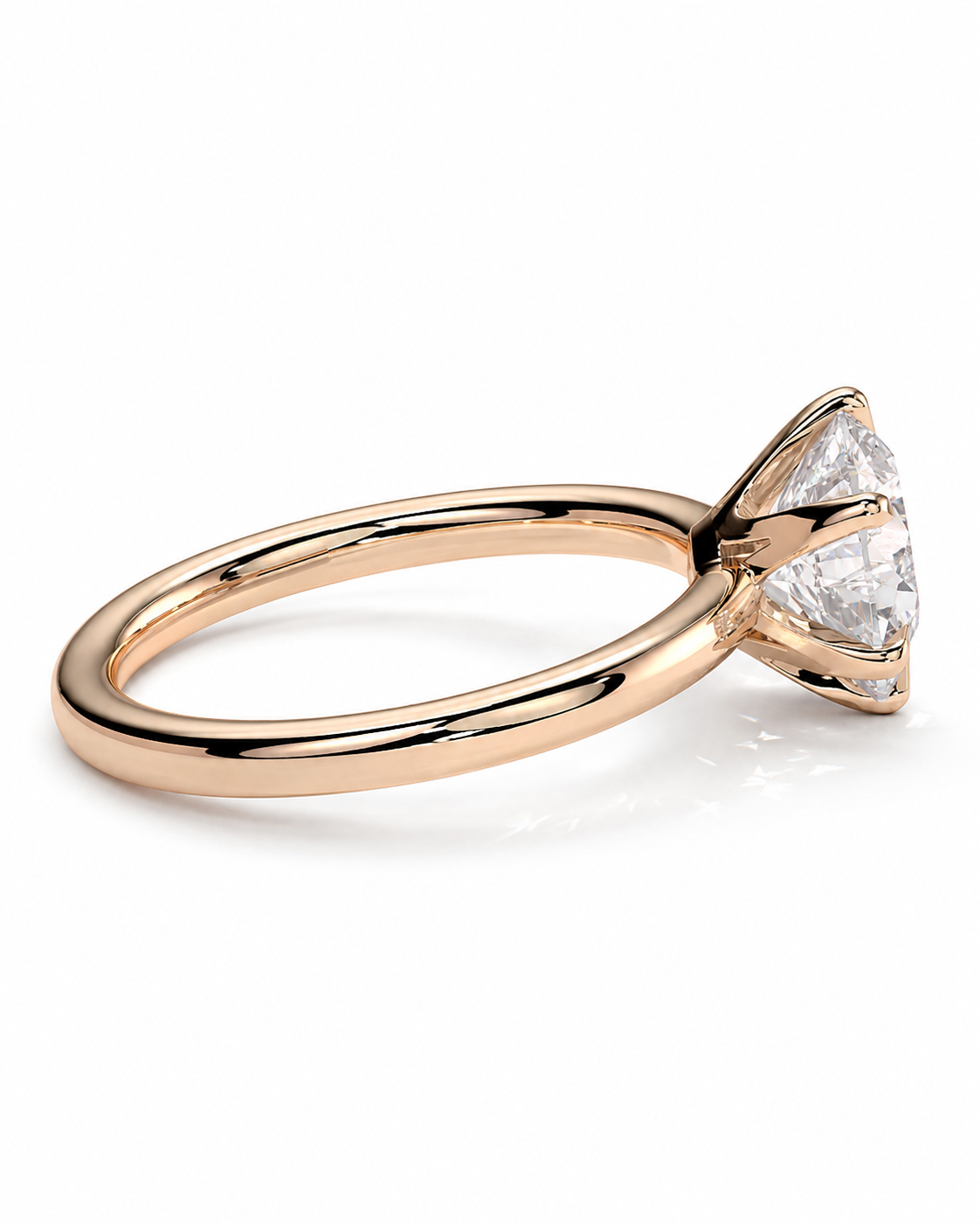 color_10K_RG, color_14K_RG &&A rose gold solitaire engagement ring with a triangular prong setting holding a clear round-cut gemstone, shown on a clean white background.