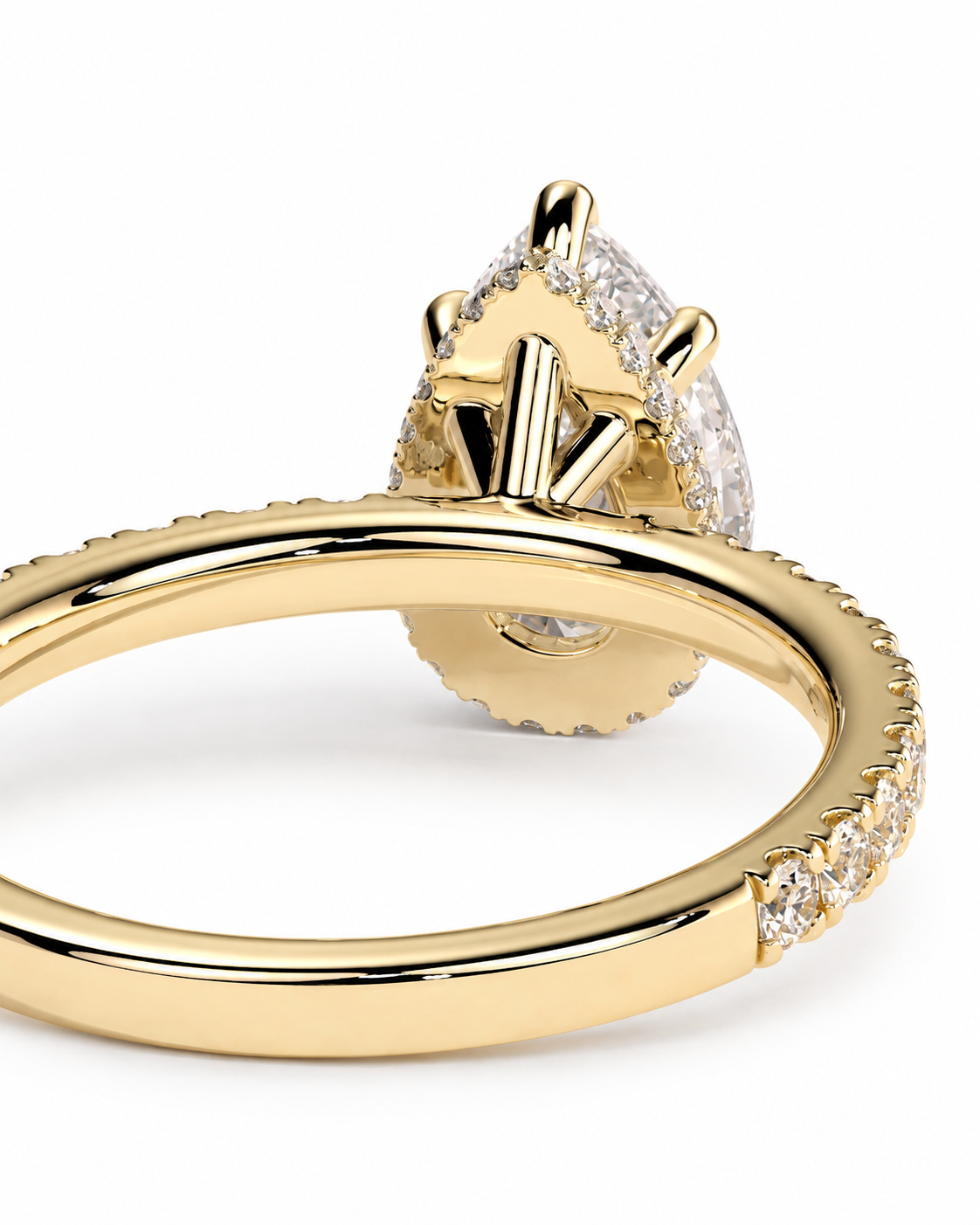 color_10K_YG, color_14K_YG &&A close-up shot of a yellow gold ring with a large pear-cut diamond center stone and smaller diamonds along the band, set against a plain white background.