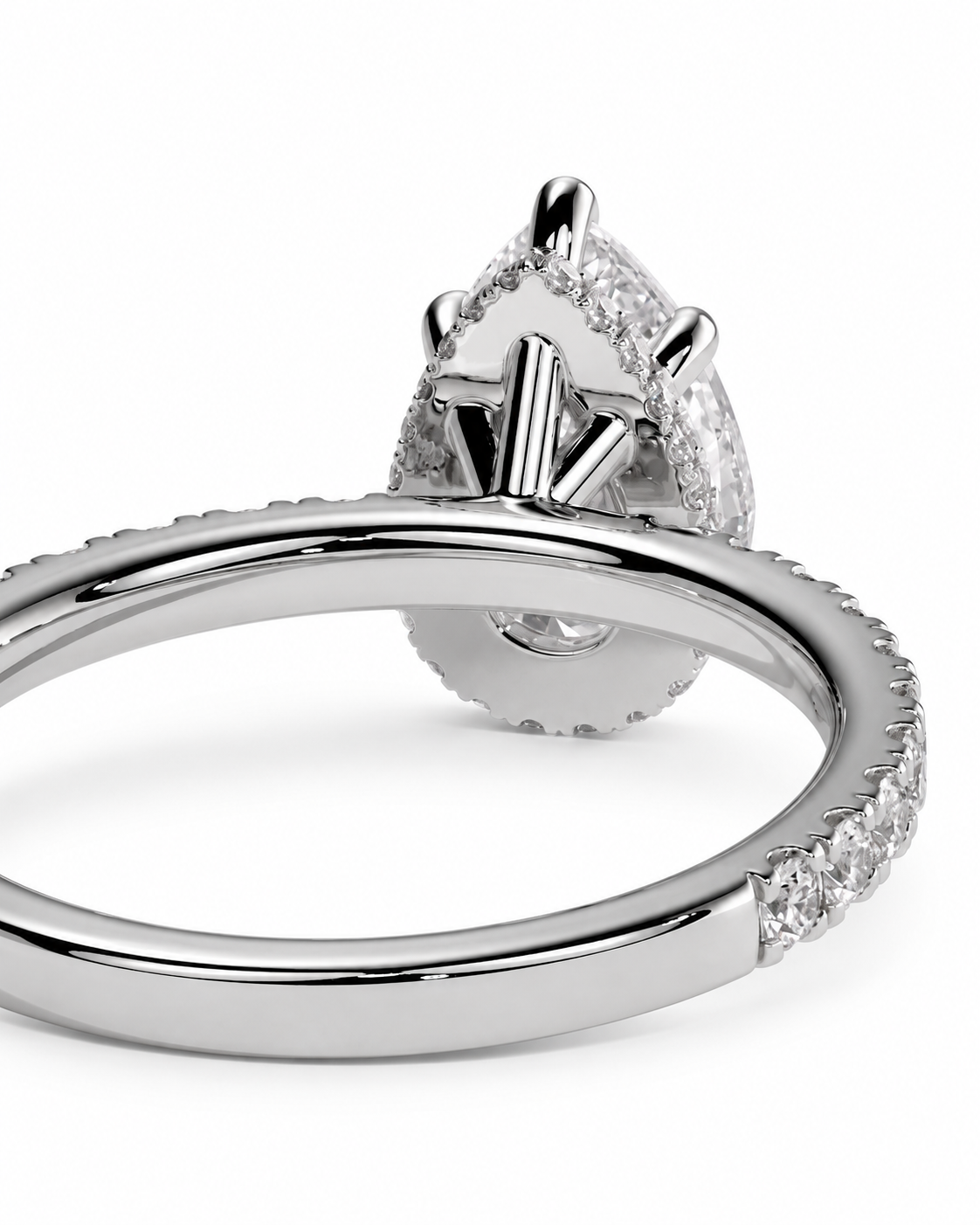 color_925_SIL,color_935_ARG,color_10K_WG, color_14K_WG &&A close-up studio shot of a silver-toned ring with a teardrop-shaped clear gemstone and pavé-set band details on a white background.