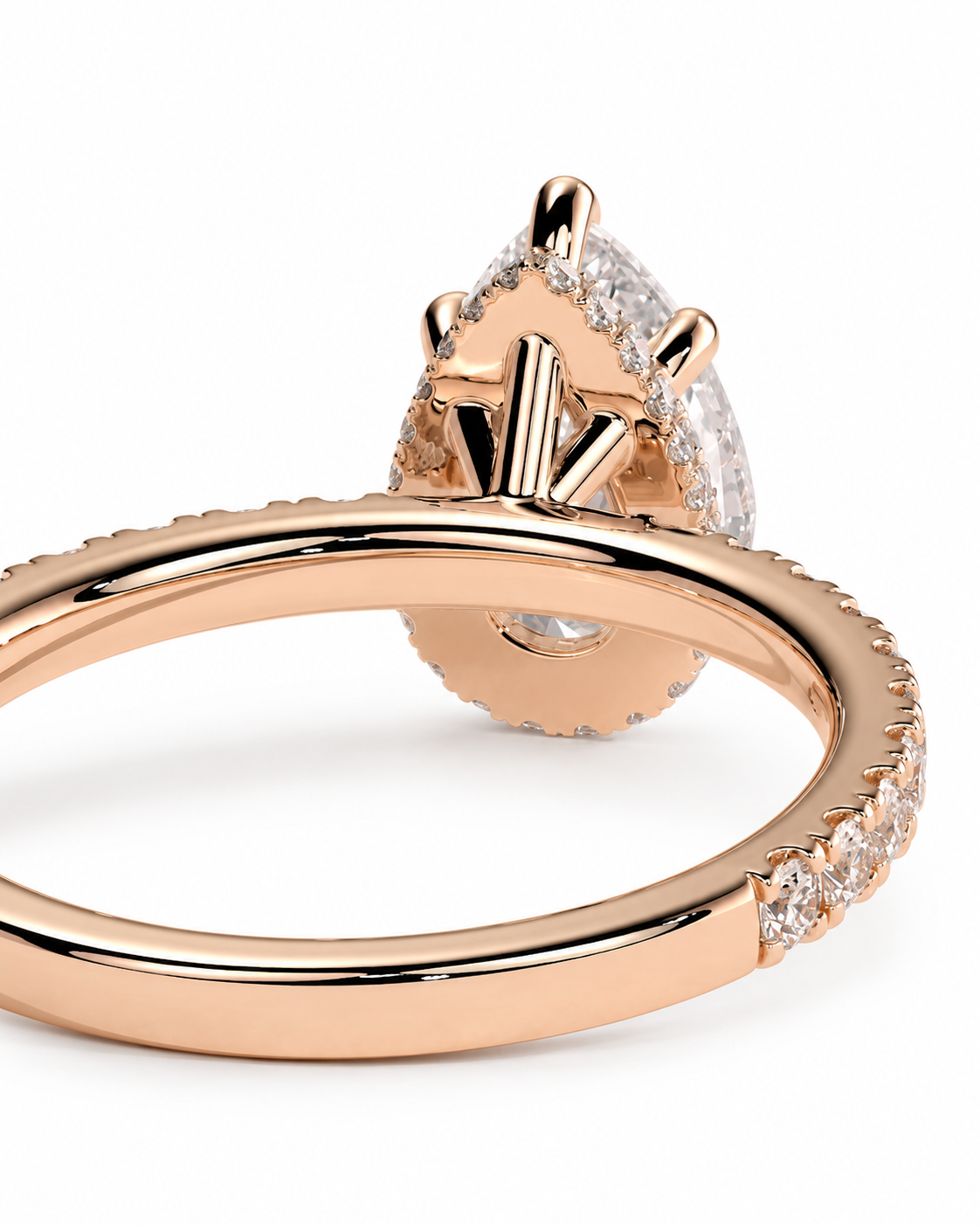 color_10K_RG, color_14K_RG &&Rose gold ring with a teardrop-shaped clear gemstone and small accent stones along the band, shown on a clean white background.