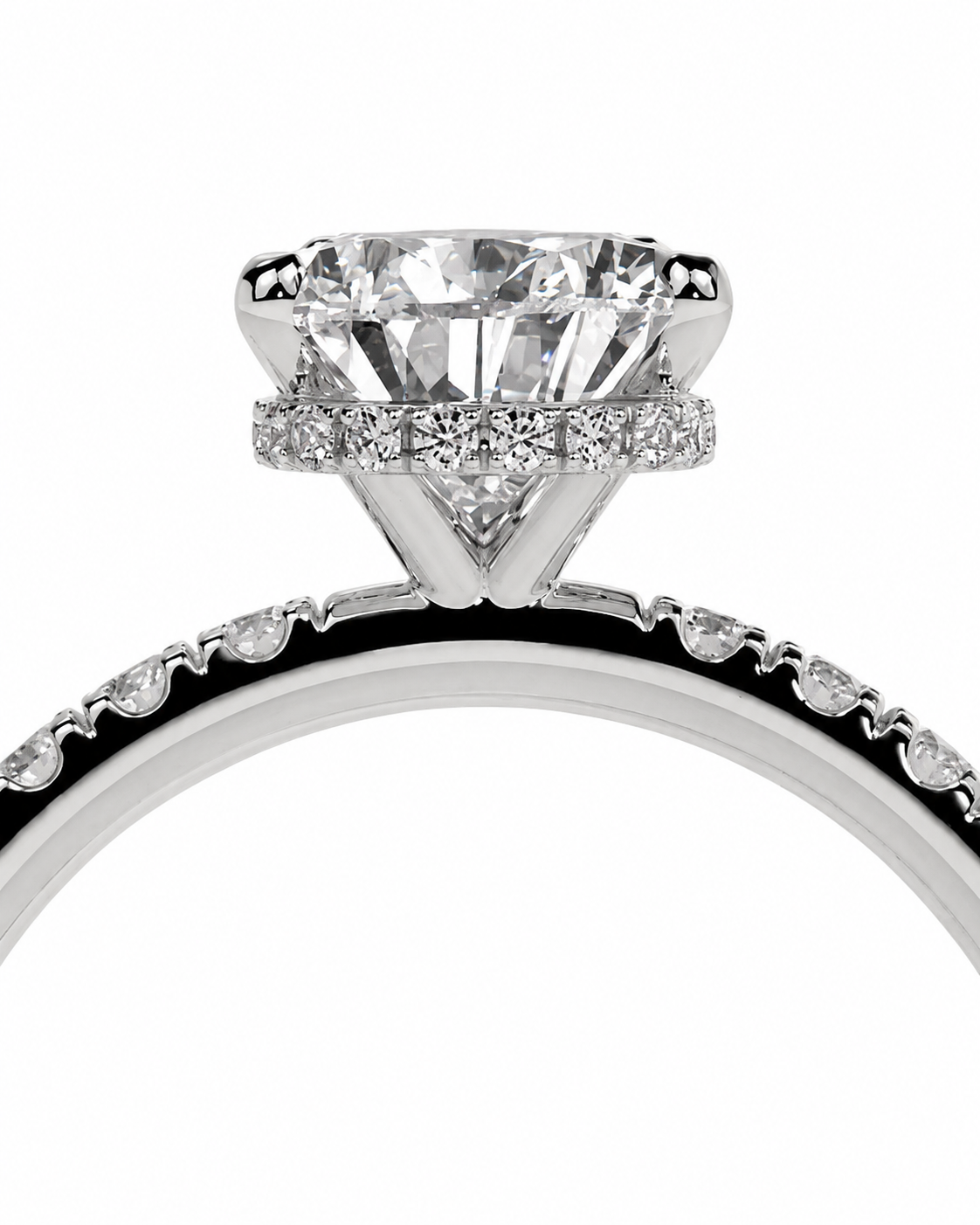 color_925_SIL,color_935_ARG,color_10K_WG, color_14K_WG &&A close-up studio shot of a silver-toned diamond ring featuring a large round-cut center stone and a halo of smaller diamonds, with a matching pavé band on a white background.