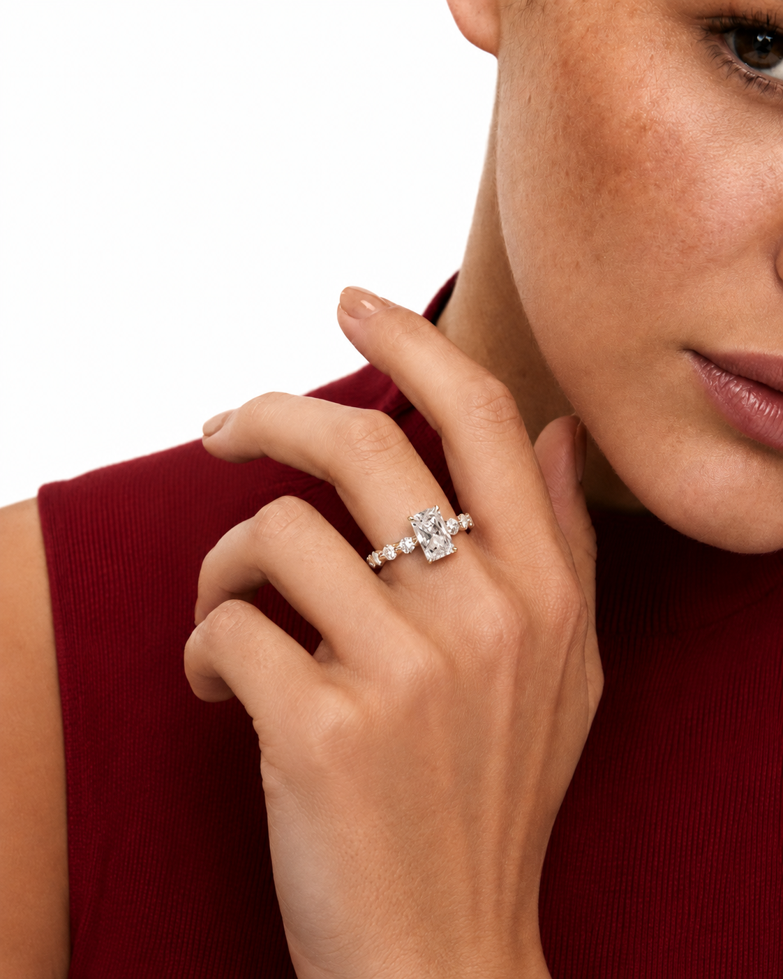 color_925_SIL,color_935_ARG,color_10K_WG, color_14K_WG &&A close-up lifestyle shot of a model wearing a diamond ring with a central cluster of round-cut diamonds and smaller side diamonds on a white background.