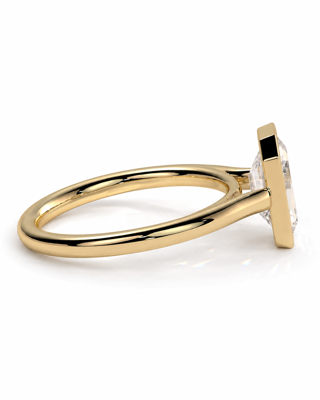color_10K_YG, color_14K_YG &&A gold ring with a square bezel setting holding a clear gemstone, shown in a side profile view against a white background.
