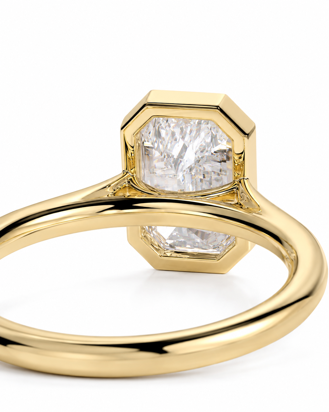 color_10K_YG, color_14K_YG &&A close-up shot of a yellow gold ring featuring a large, faceted clear gemstone in a bezel setting with a geometric, stepped octagonal design.