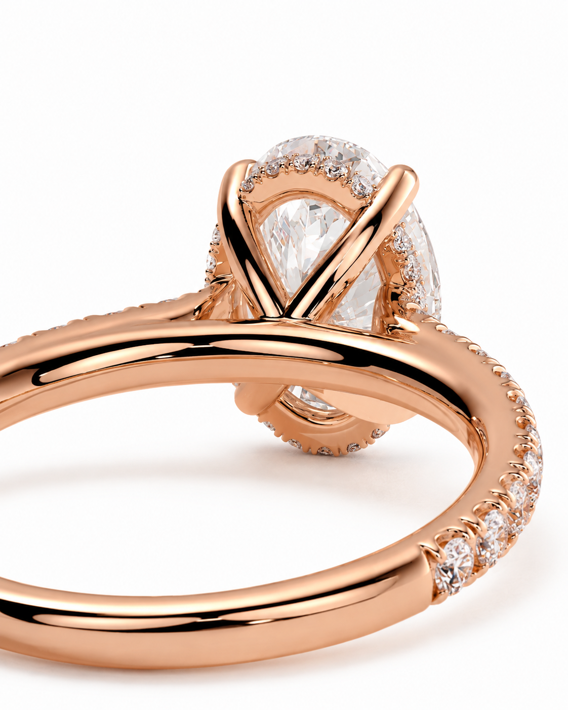 color_10K_RG, color_14K_RG &&Rose gold ring with a pear-cut clear center stone and small pavé-set stones along the band, shown on a clean white background.