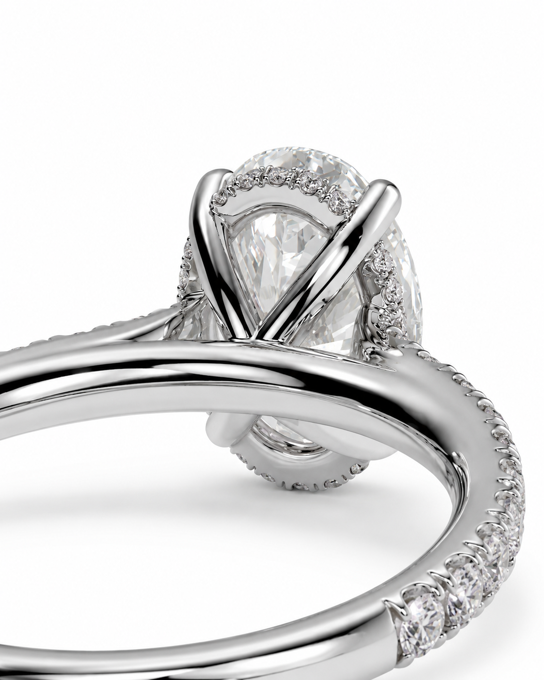 color_925_SIL,color_935_ARG,color_10K_WG, color_14K_WG &&A close-up studio shot of a silver-toned diamond ring featuring a pear-cut center stone in a prong setting with a halo and pavé band, shown on a white background.