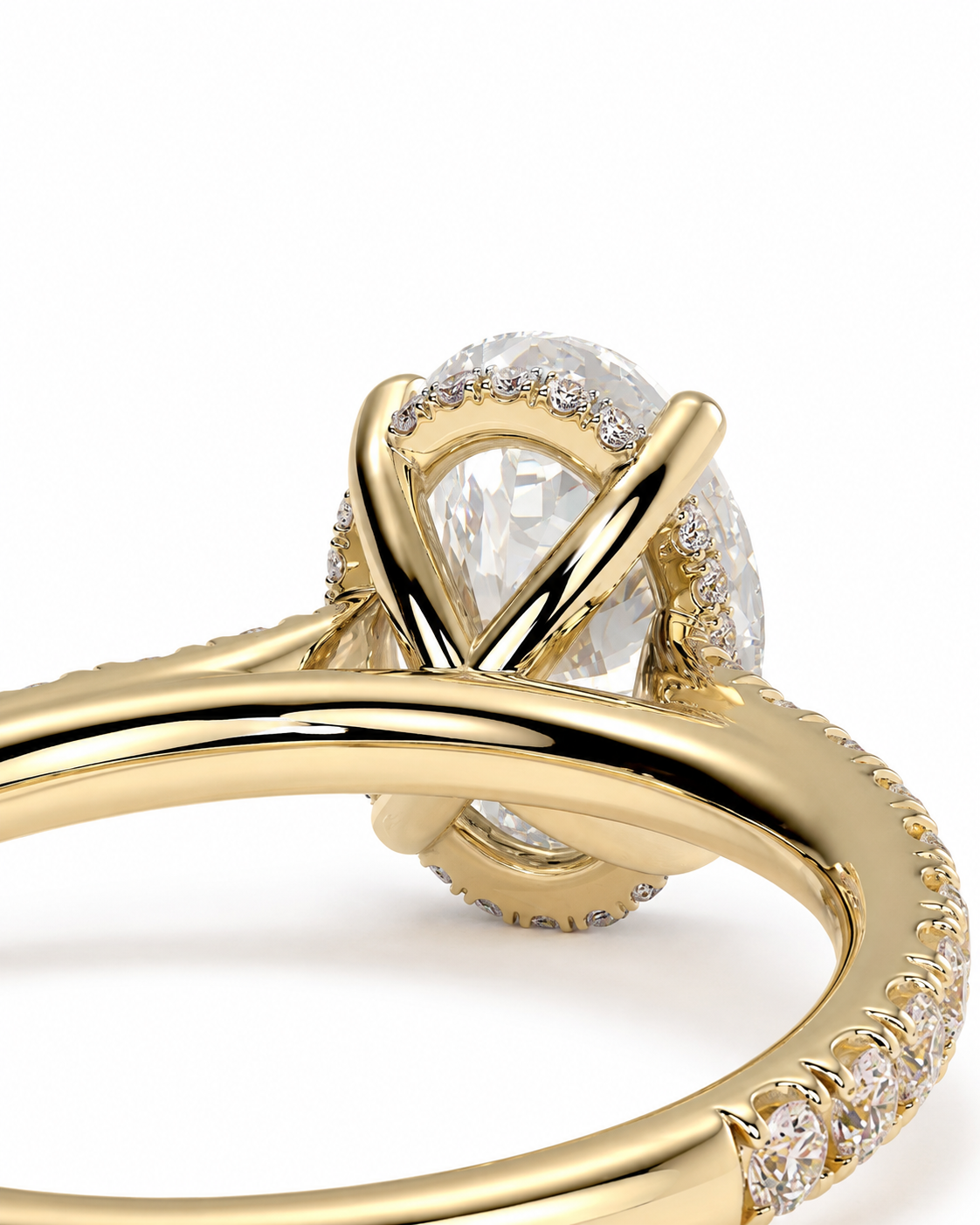 color_10K_YG, color_14K_YG &&A close-up of a yellow gold ring featuring a large pear-cut clear center stone surrounded by small clear accent stones, set on a polished gold band with pavé detailing.