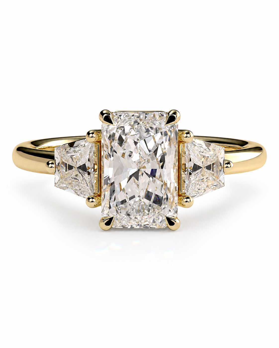 color_10K_YG, color_14K_YG &&A yellow gold three-stone ring featuring a large rectangular emerald-cut center diamond flanked by two smaller round brilliant-cut diamonds, set against a clean white background.