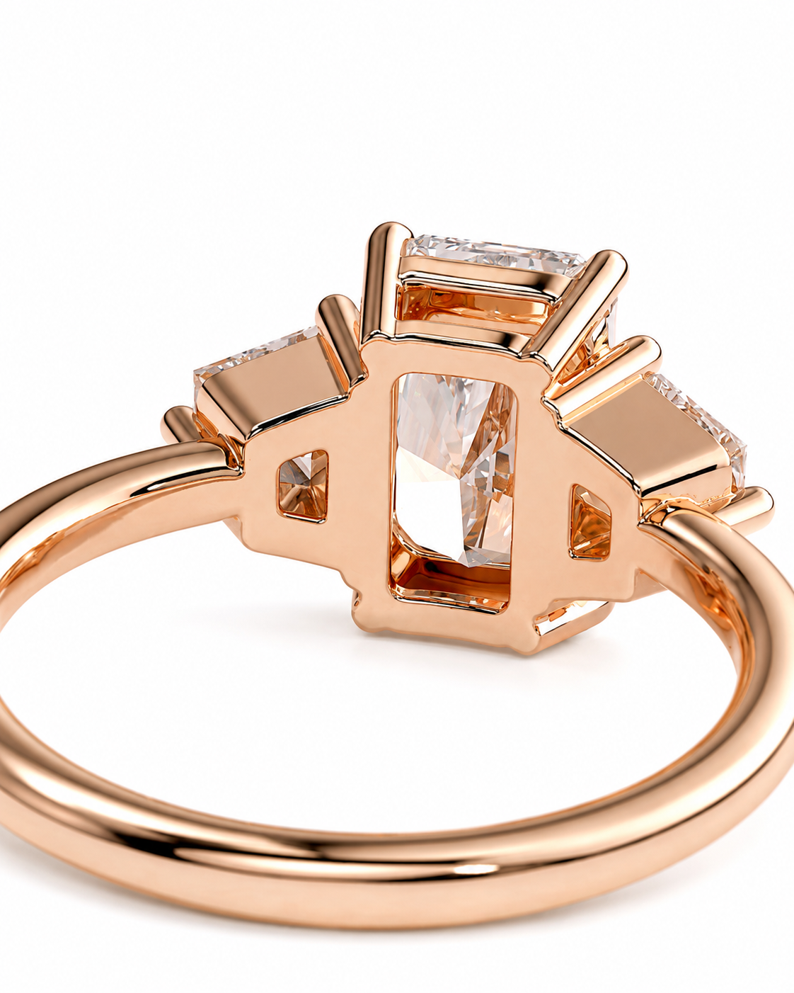 color_10K_RG, color_14K_RG &&Rose gold ring with a rectangular emerald-cut center stone and smaller side stones, shown on a clean white background.