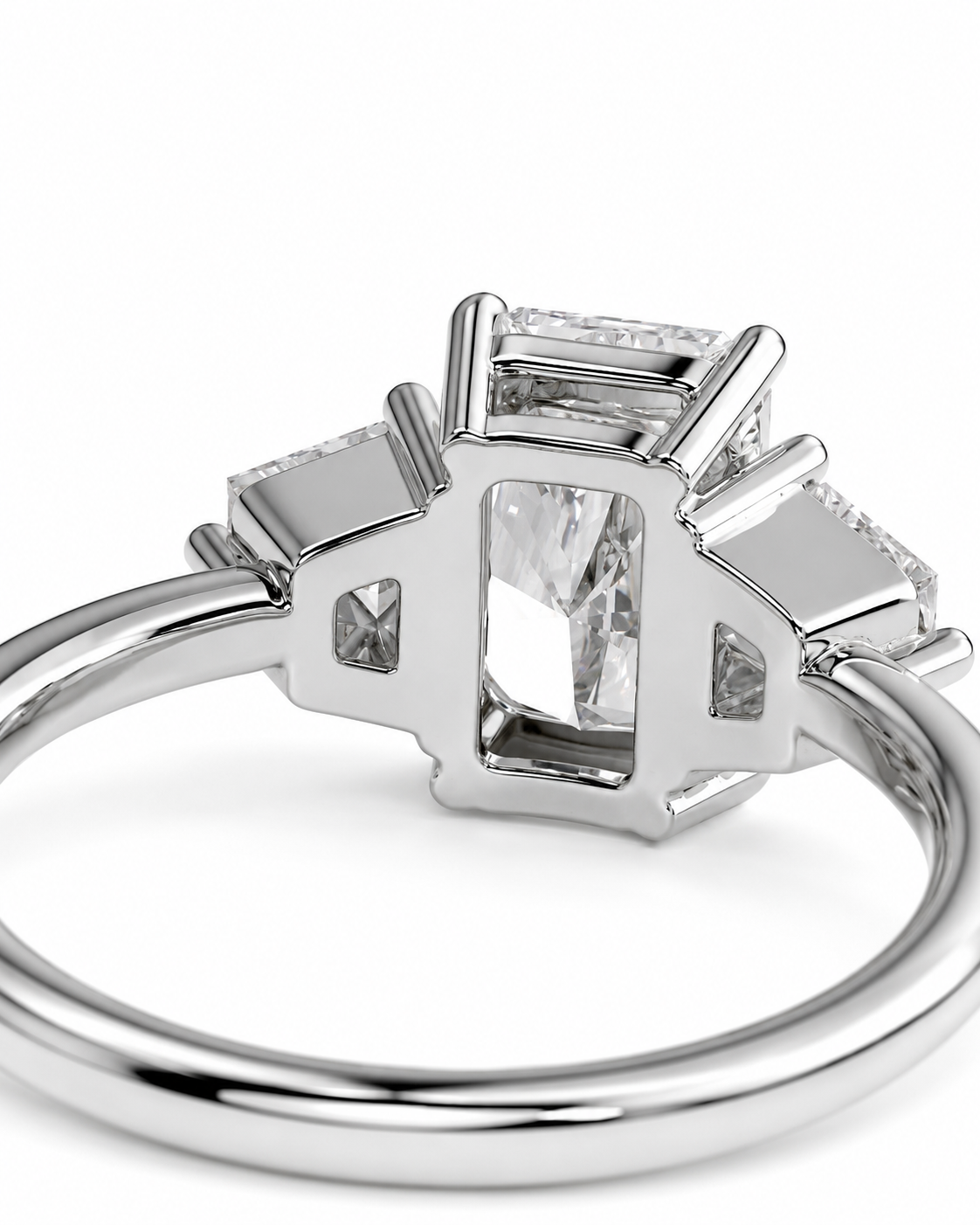 color_925_SIL,color_935_ARG,color_10K_WG, color_14K_WG &&A silver-toned ring featuring a rectangular emerald-cut center stone with smaller accent stones on each side, shown on a clean white background.