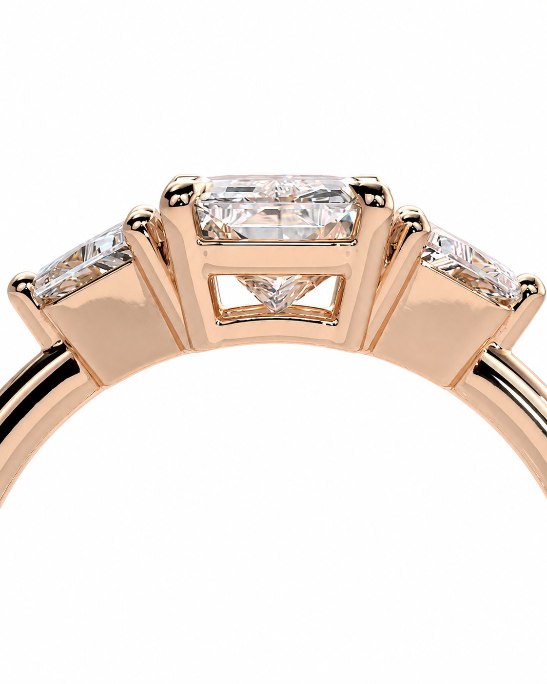 color_10K_RG, color_14K_RG &&A close-up of a rose gold ring featuring a central rectangular baguette diamond flanked by two smaller baguette diamonds on the shoulders, set against a plain white background.