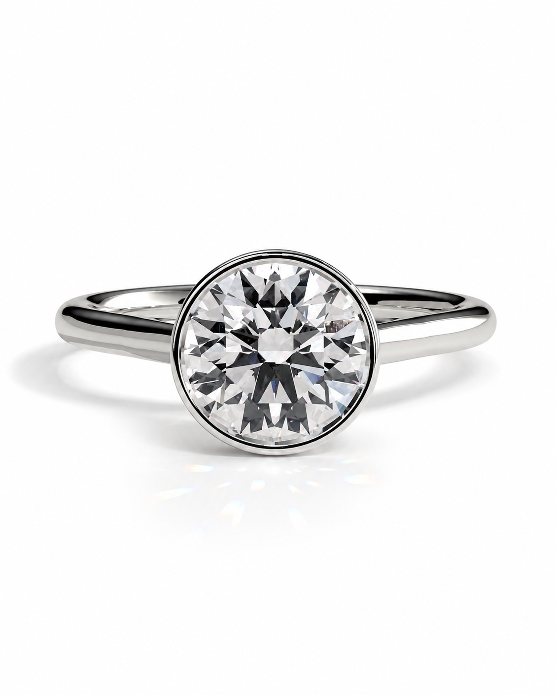 color_925_SIL,color_935_ARG,color_10K_WG, color_14K_WG &&A round-cut diamond engagement ring with a polished silver-colored band, shown on a clean white background with a soft reflection.