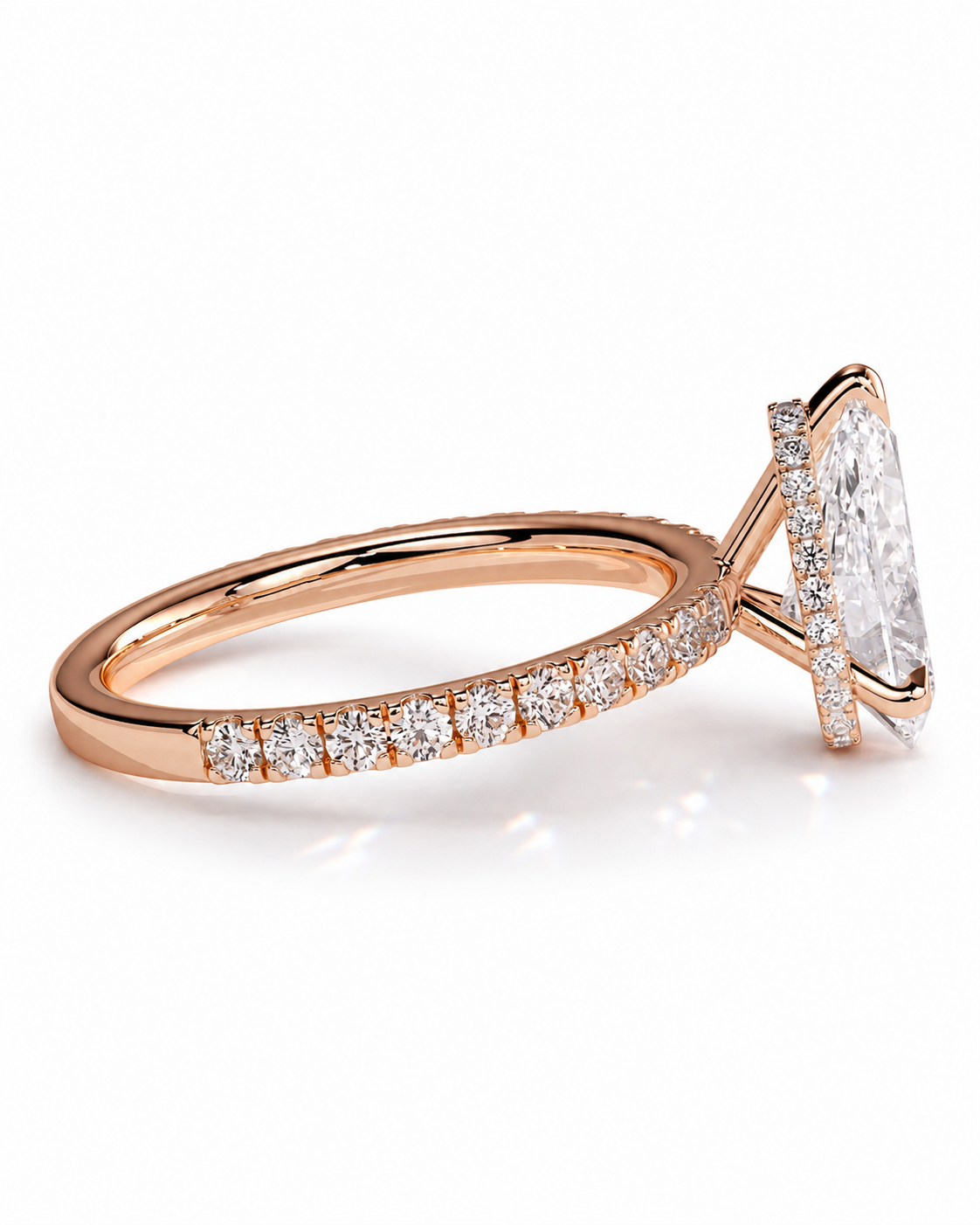 color_10K_RG, color_14K_RG &&A rose gold engagement ring featuring a large oval-cut clear gemstone in a prong setting, with a pavé band of smaller round-cut diamonds on a clean white background.