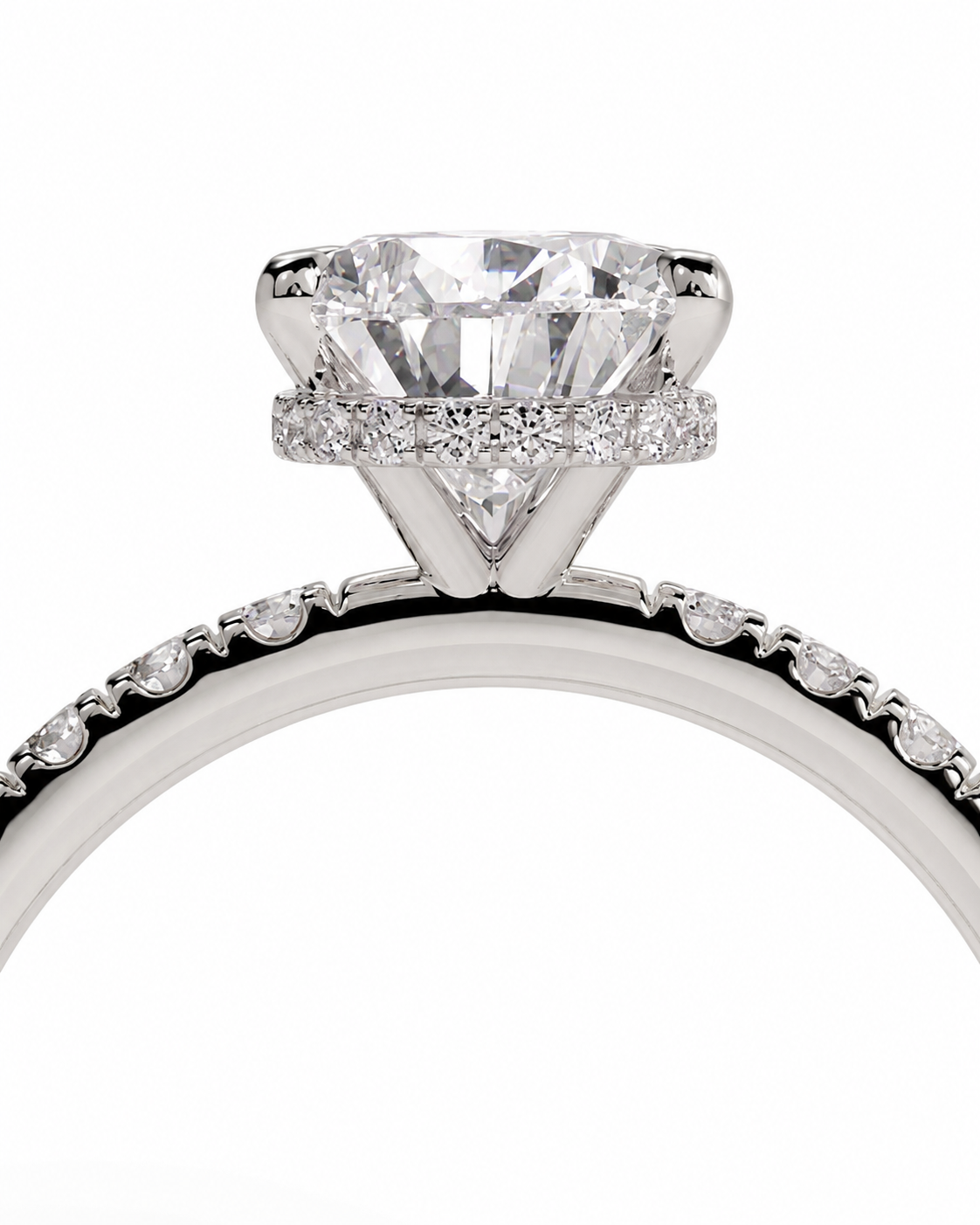 color_925_SIL,color_935_ARG,color_10K_WG, color_14K_WG &&A close-up studio shot of a diamond engagement ring featuring a large round-cut center stone in a prong setting, surrounded by a halo of small diamonds, with a pavé-set band on a white background.
